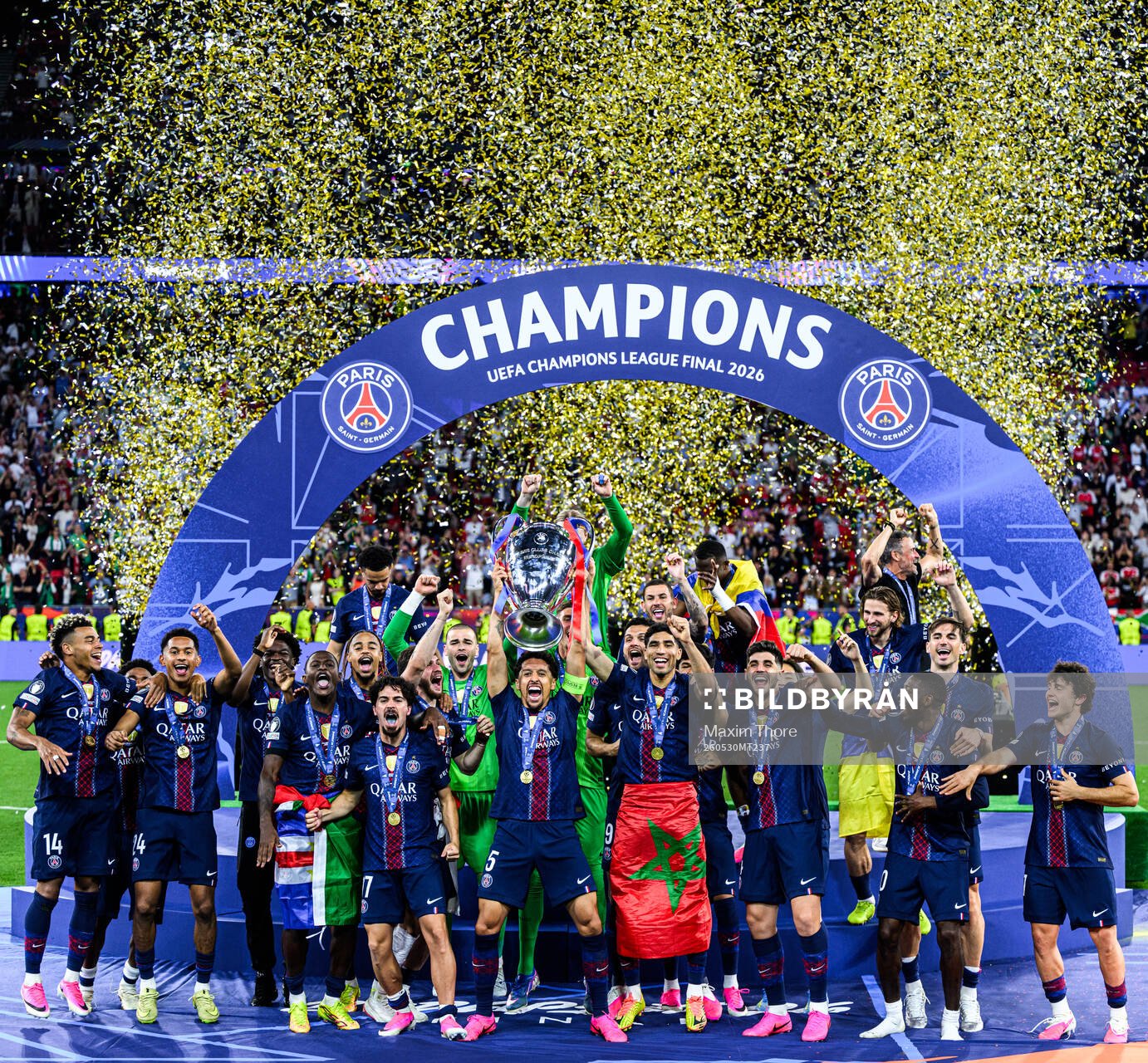 Players of Paris Saint-Germain celebrate with the trophy