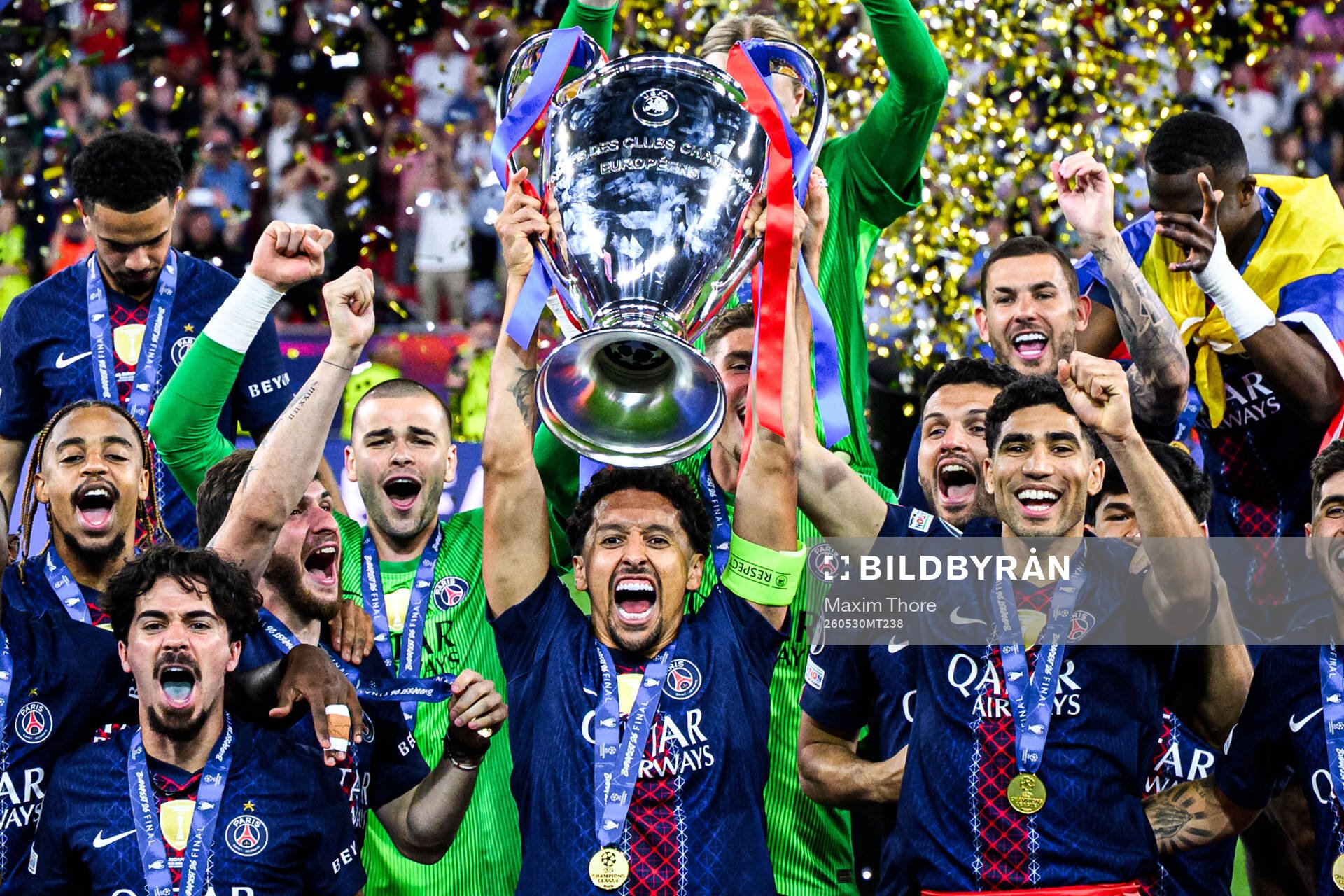 Players of Paris Saint-Germain celebrate with the trophy