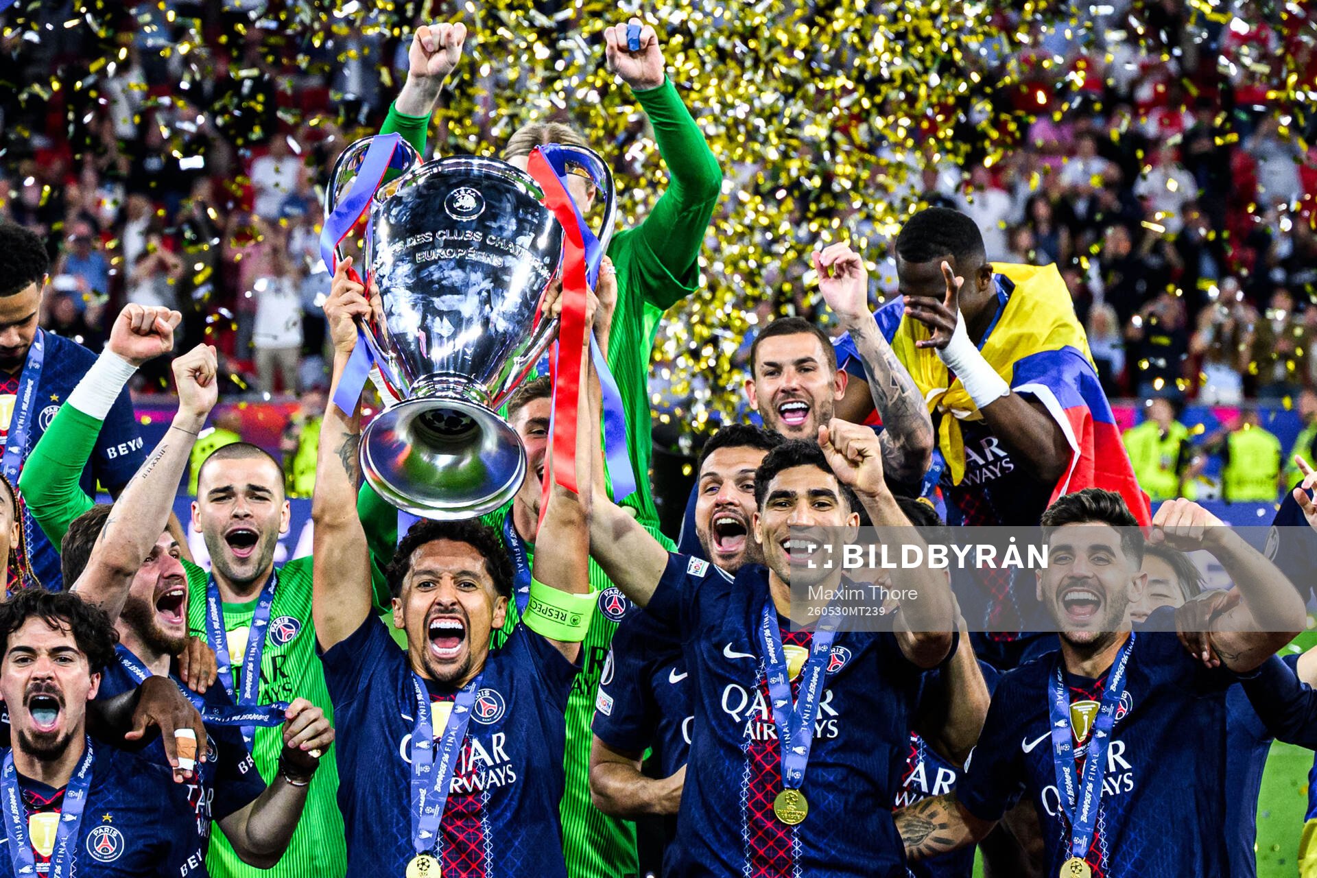 Players of Paris Saint-Germain celebrate with the trophy