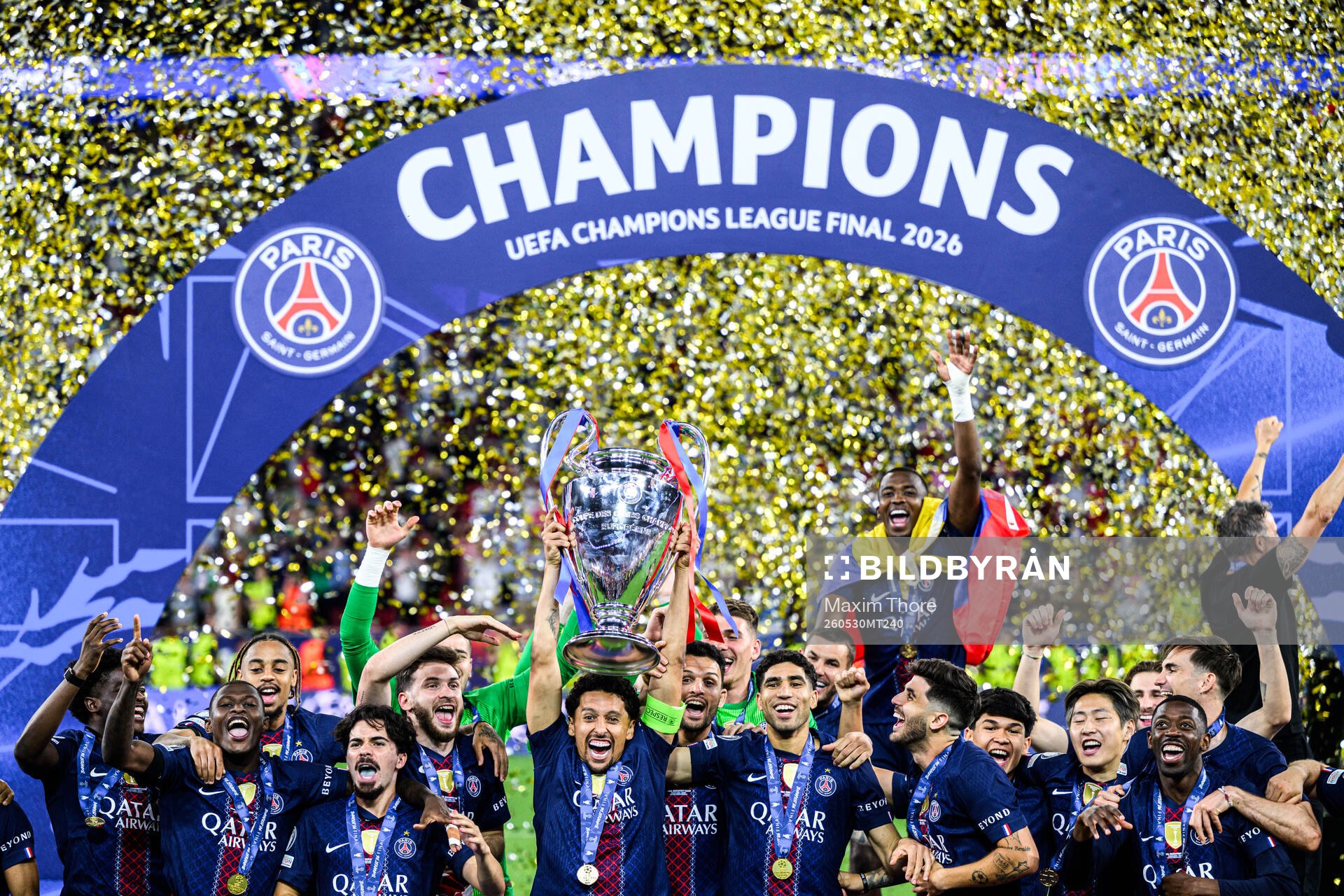 Players of Paris Saint-Germain celebrate with the trophy