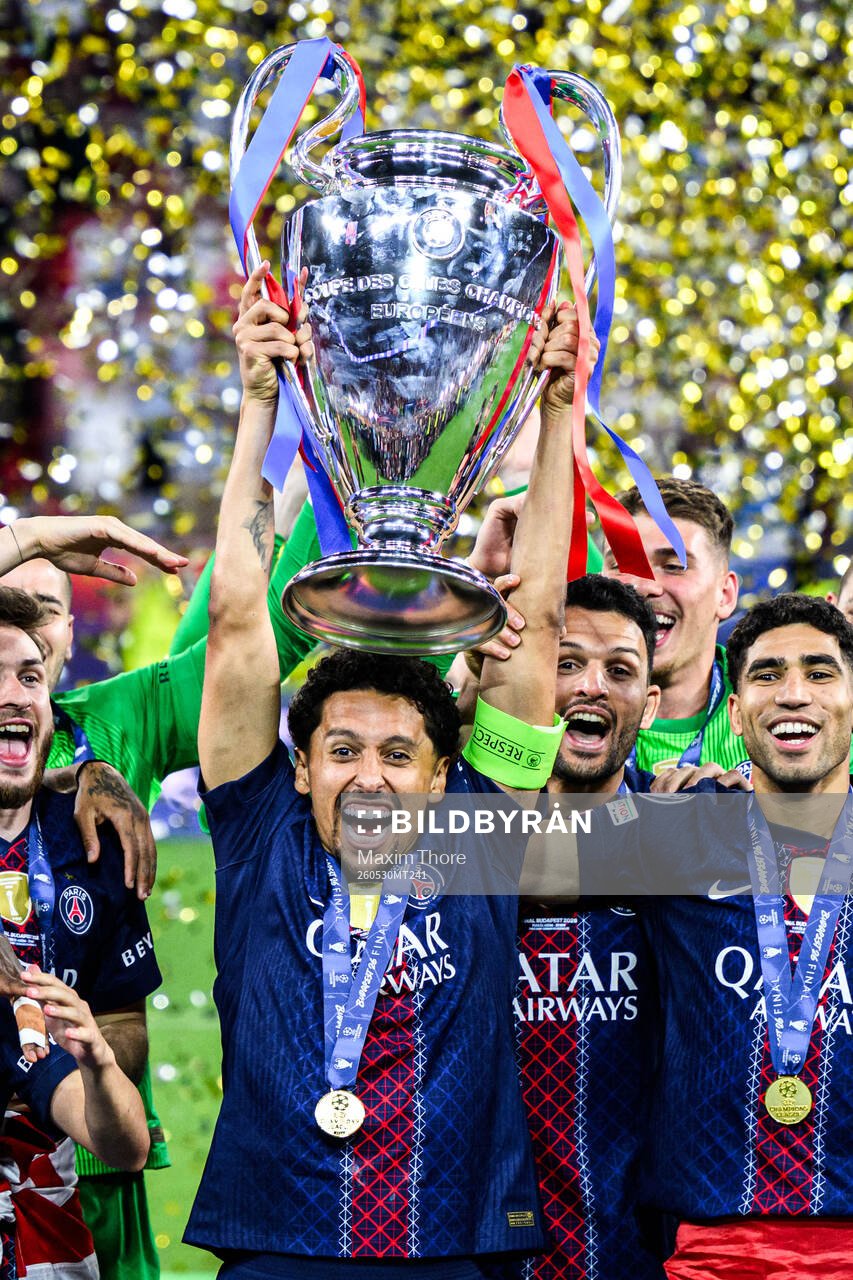 Players of Paris Saint-Germain celebrate with the trophy