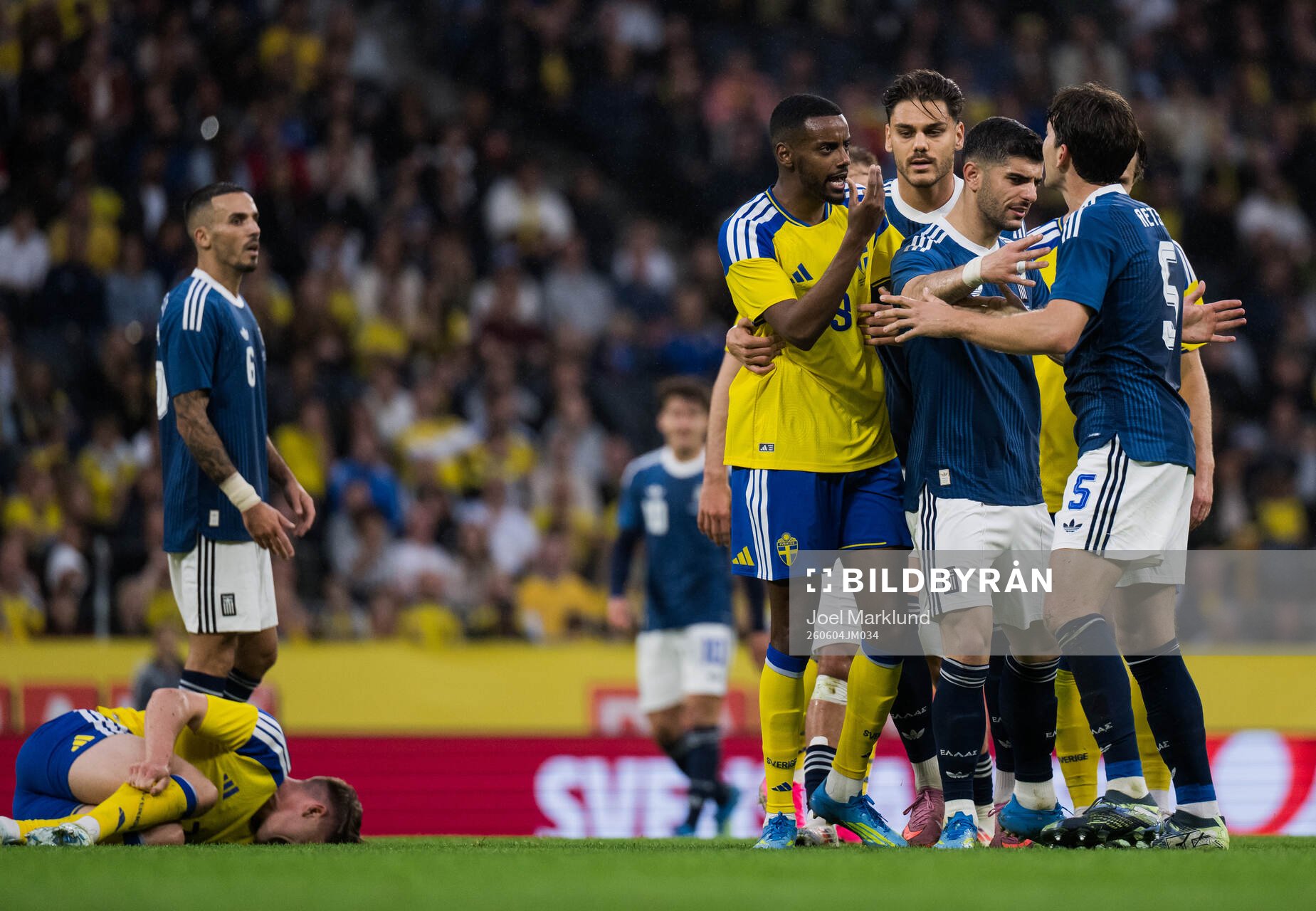 Alexander Isak of Sweden reacts at Panagiotis Retsos of