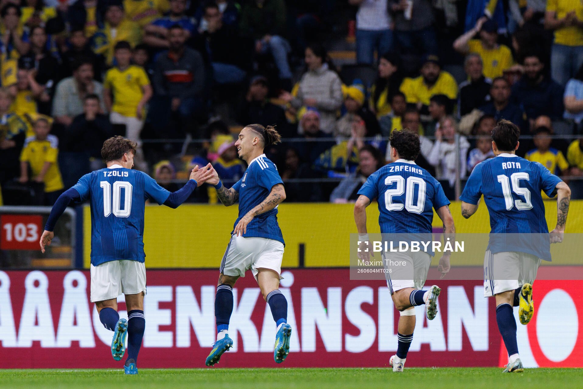 Kostas Tsimikas of Greece celebrates with team mates