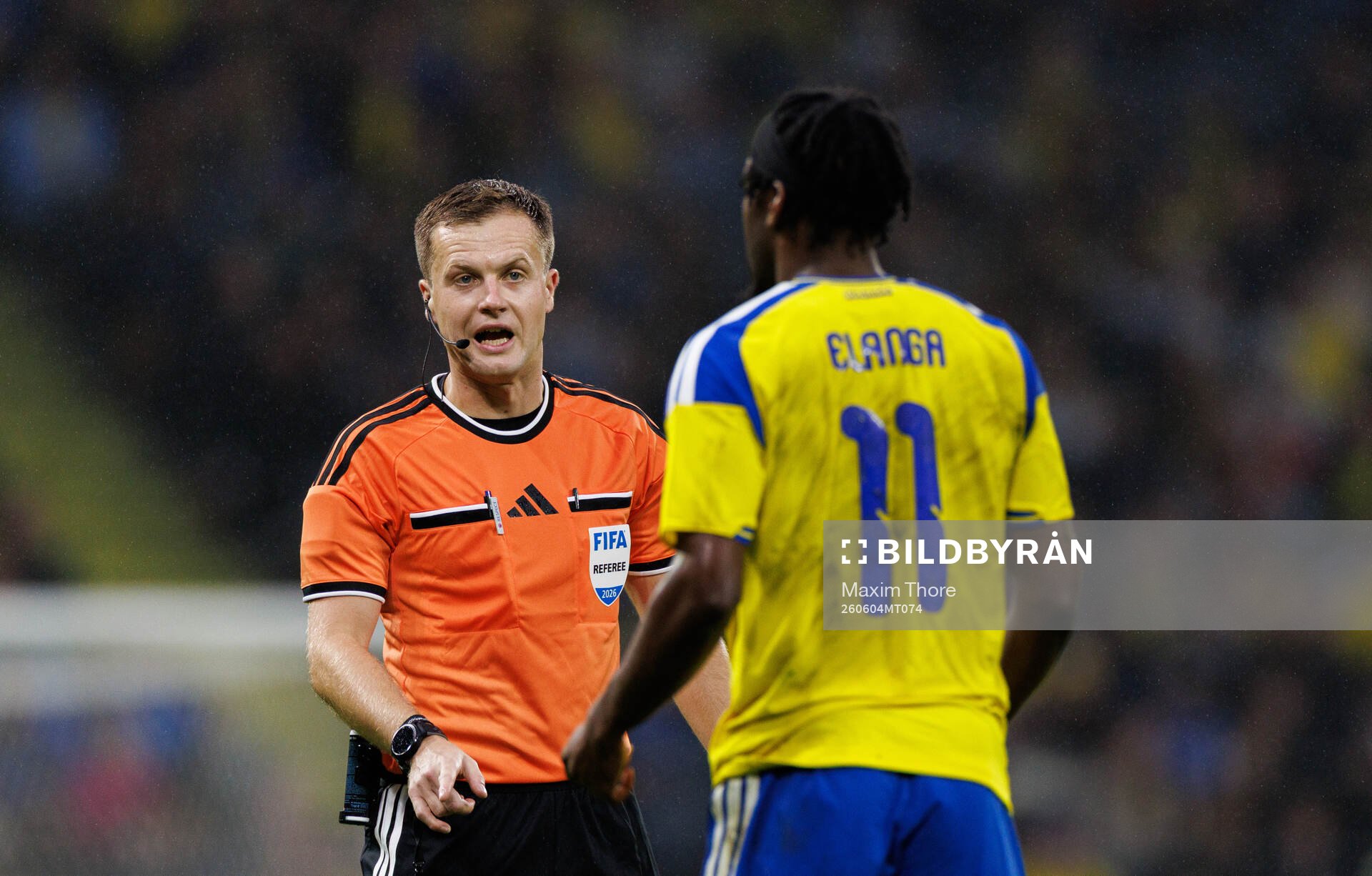 Referee Aaron Wyn Jones and Anthony Elanga of Sweden