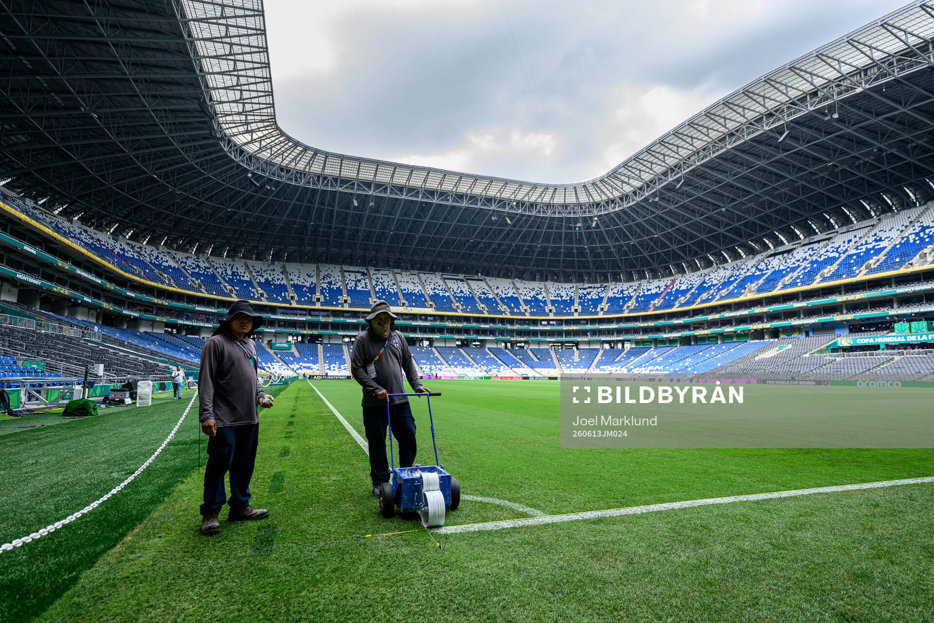 Workers prepare the pitch