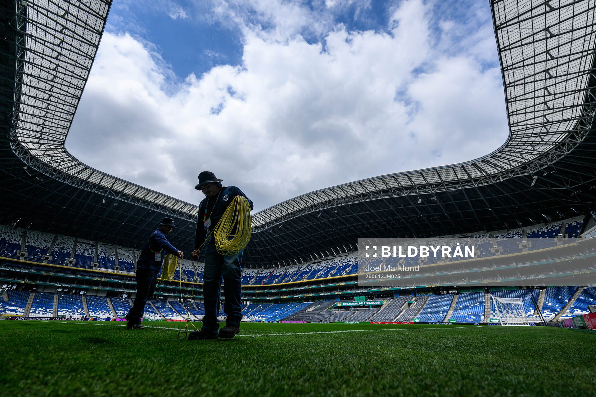 Workers prepare the pitch