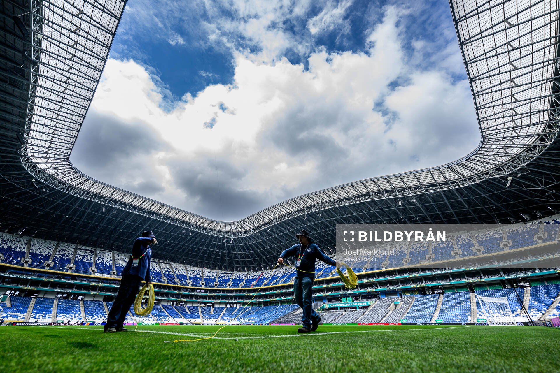 Workers prepare the pitch