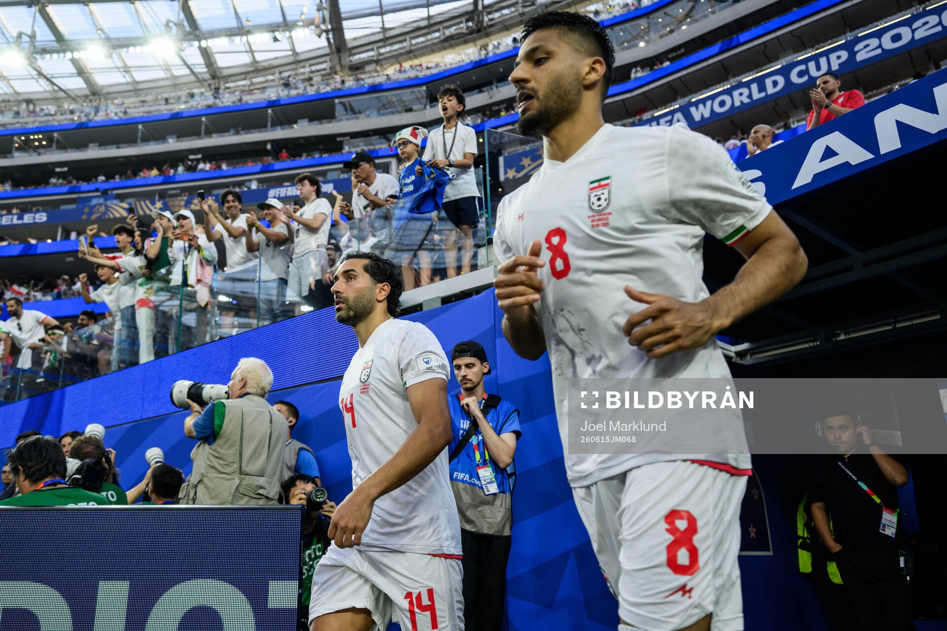 Saman Ghoddos and Mohammad Mohebbi of Iran enter the pitch