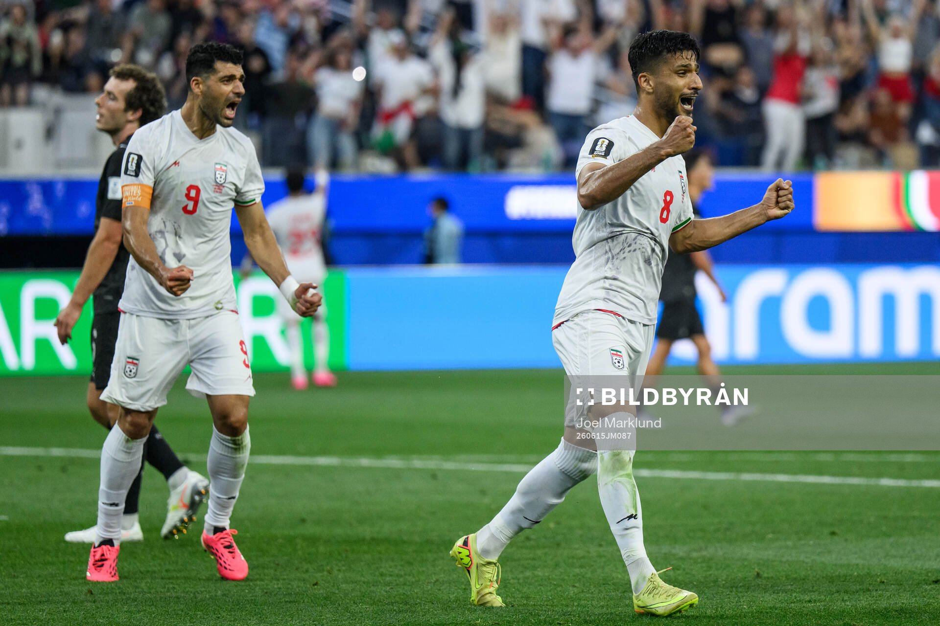 Mehdi Taremi and Mohammad Mohebbi of Iran celebrate
