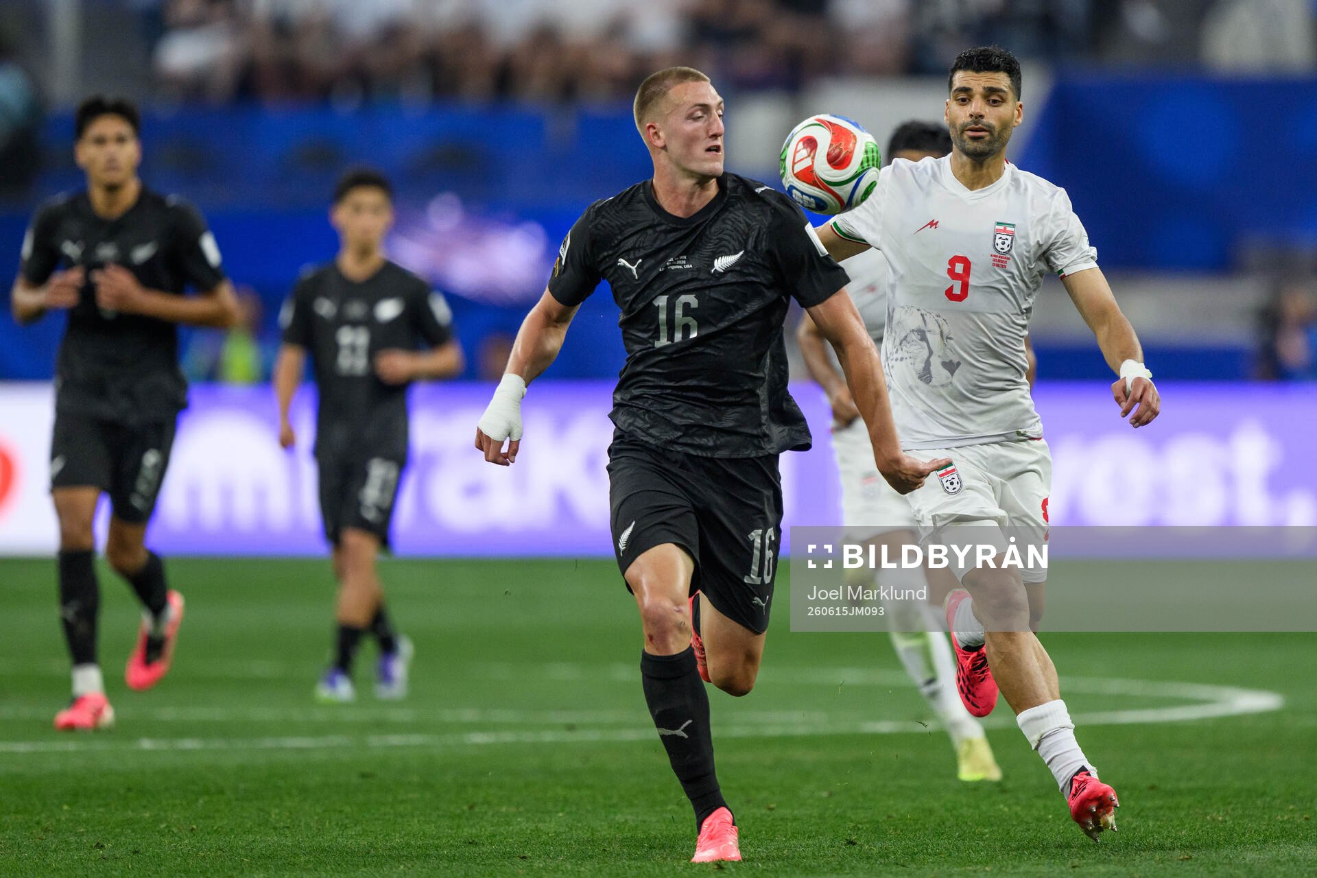 Finn Surman of New Zealand and Mehdi Taremi of Iran