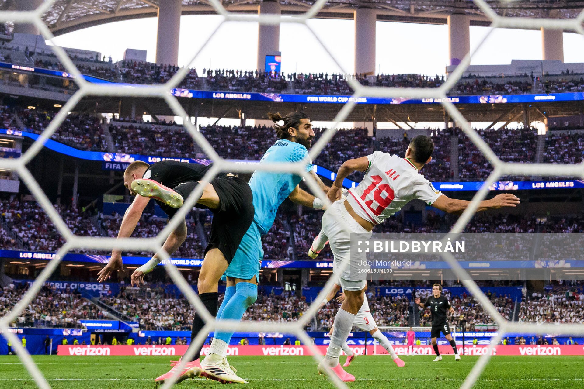 Finn Surman of New Zealand in action against goalkeeper
