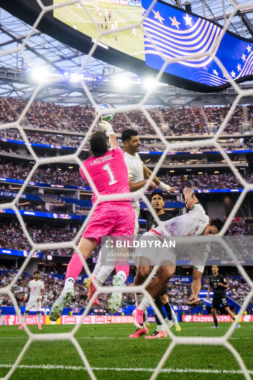 Goalkeeper Max Crocombe of New Zealand boxes the ball in