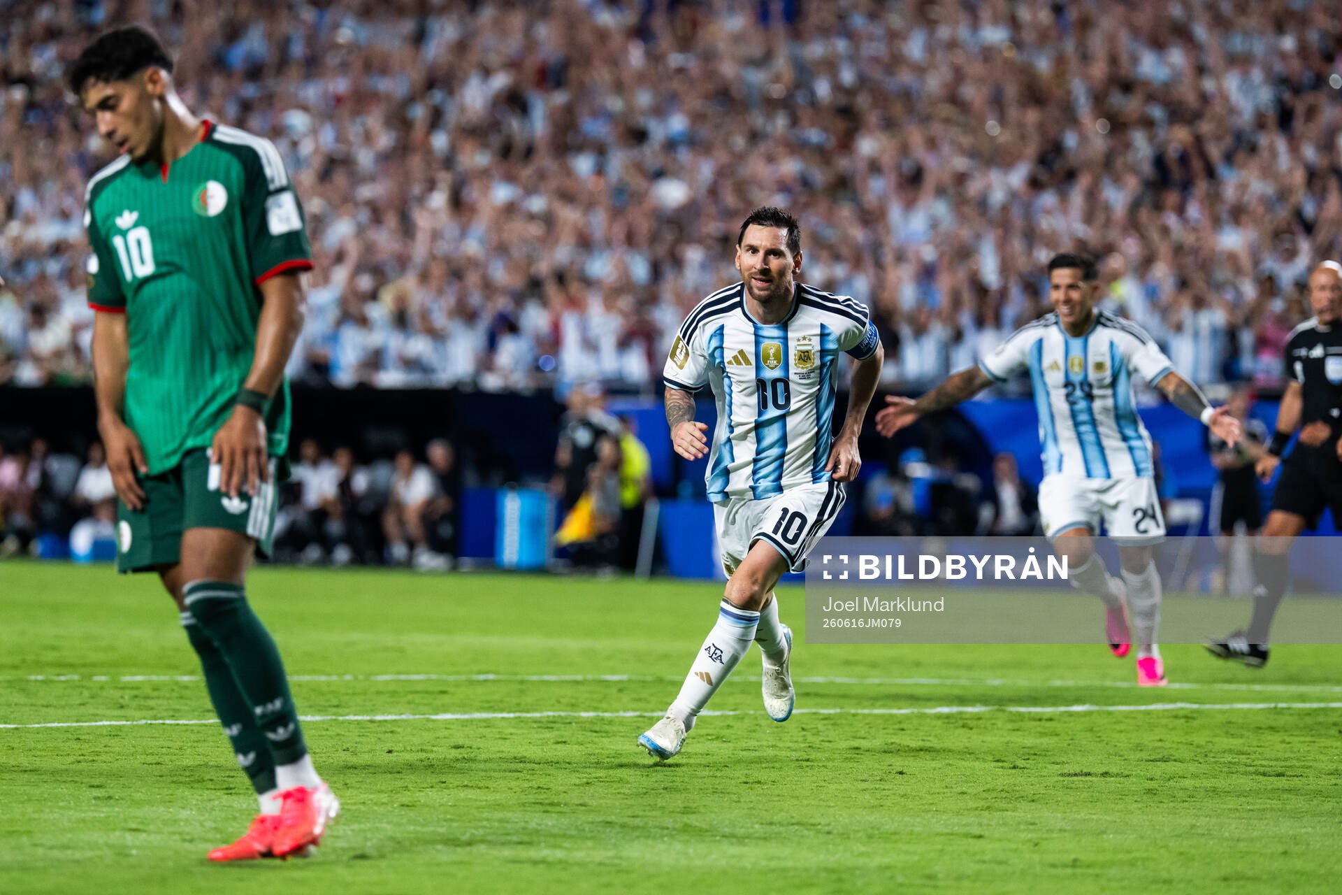 Fares Chaibi of Algeria looks dejected and Lionel Messi and