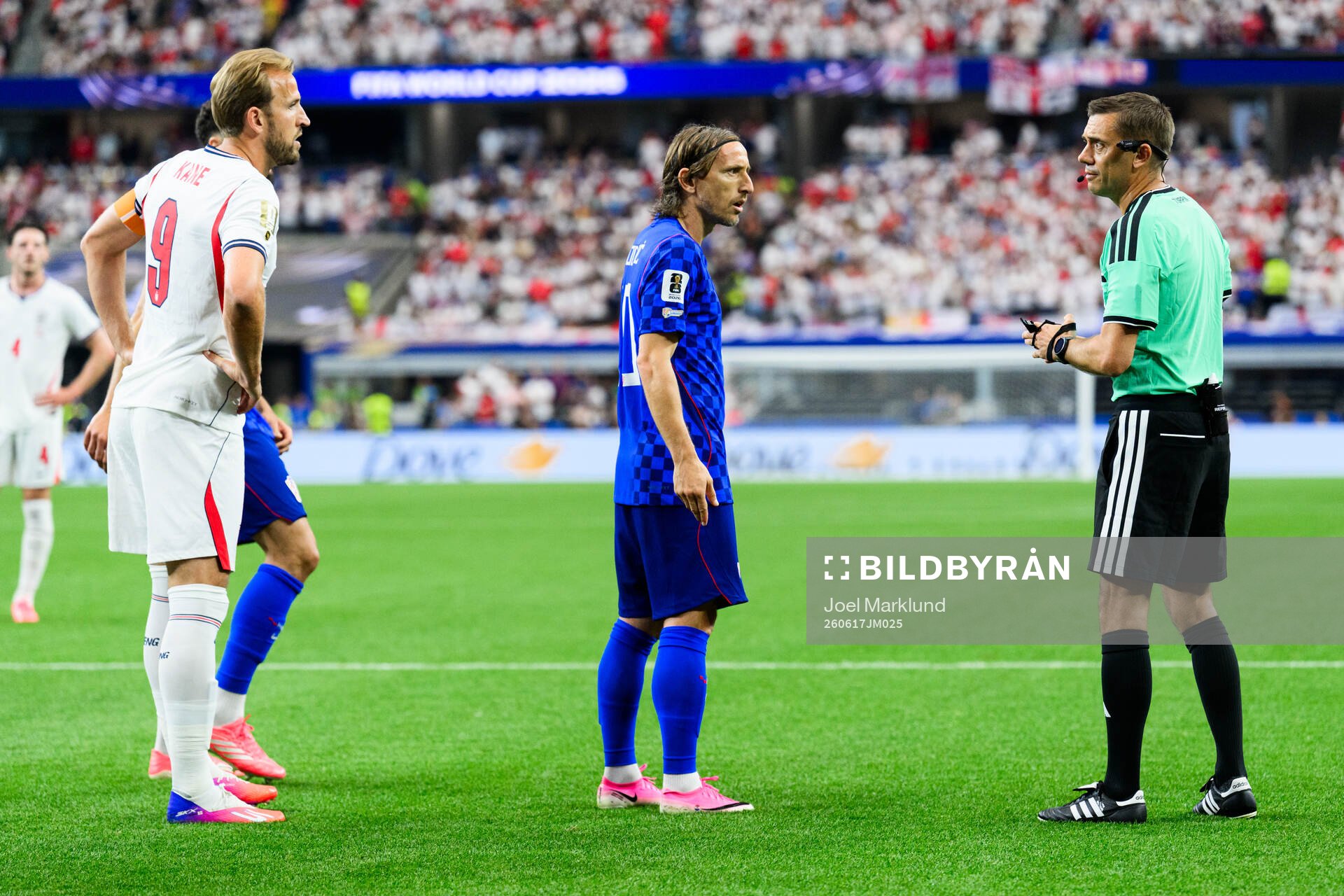 Harry Kane of England, Luka Modric of Croatia and Referee