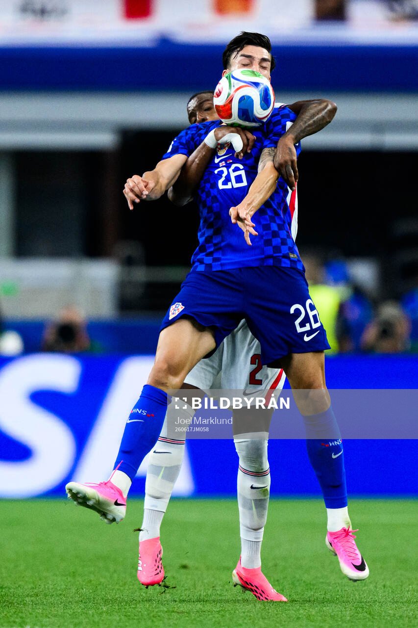Ezri Konsa of England and Petar Musa of Croatia