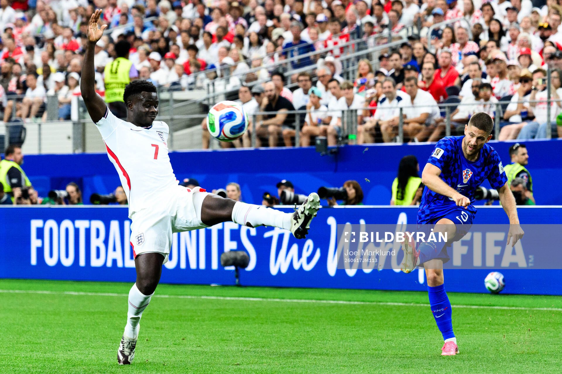 Bukayo Saka of England and Andrej Kramaric of Croatia