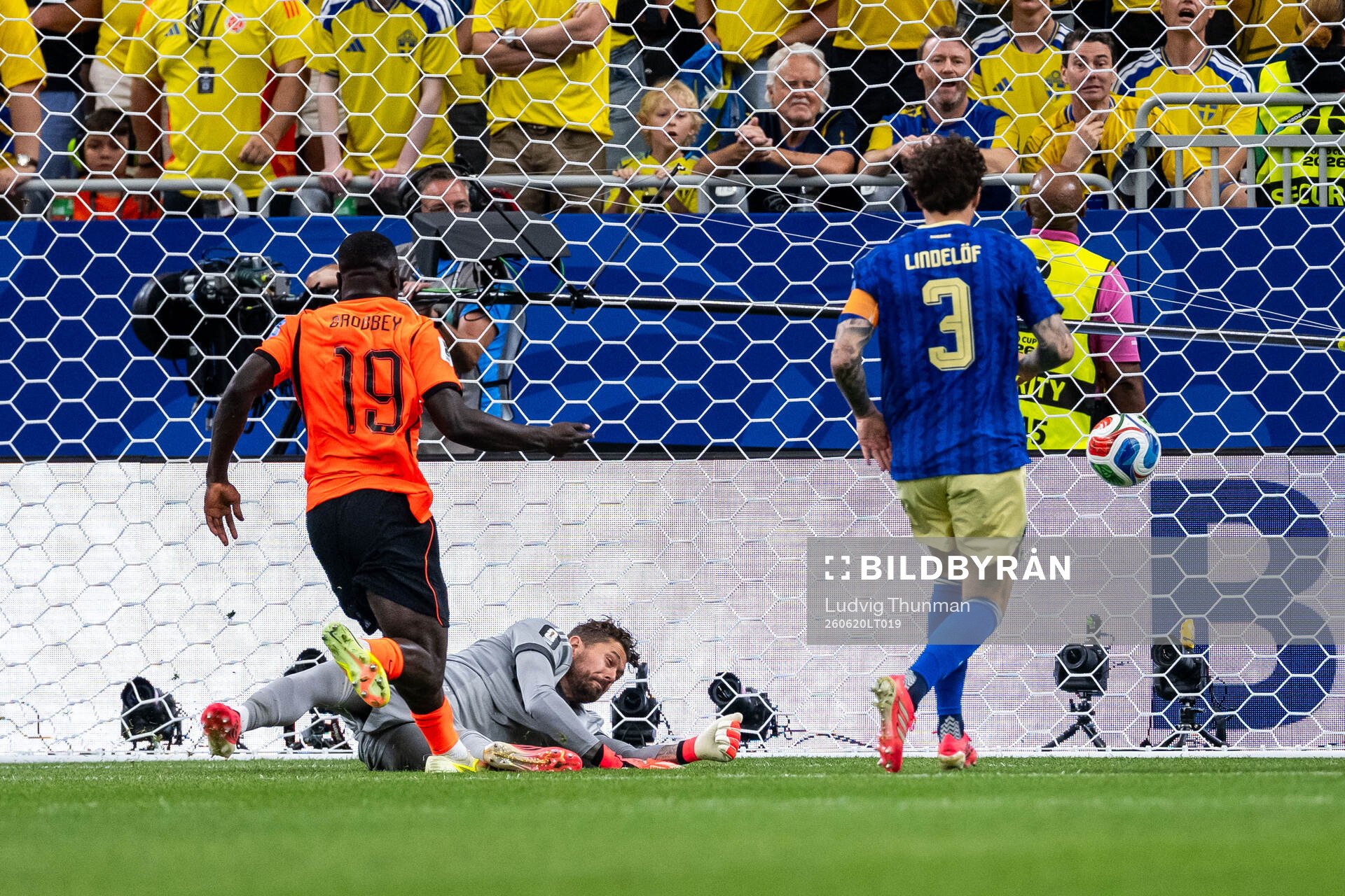 Brian Brobbey of Netherlands scores 1-0 behind goalkeeper