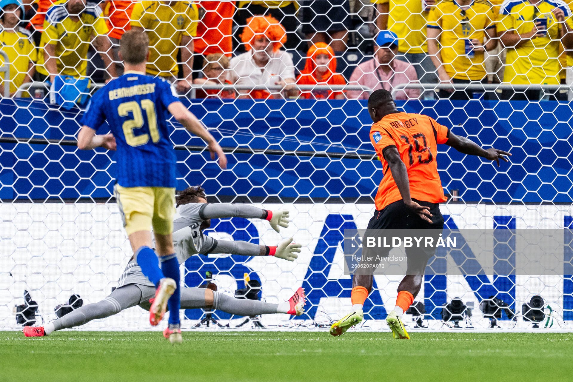 Brian Brobbey of Netherlands scores 1-0 behind goalkeeper