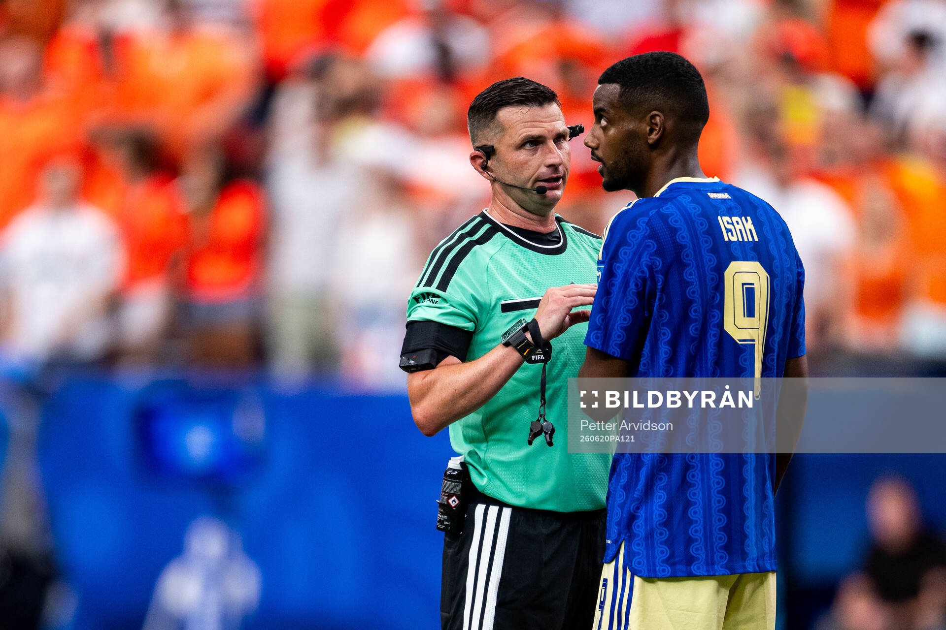 Referee Michael Oliver and Alexander Isak of Sweden