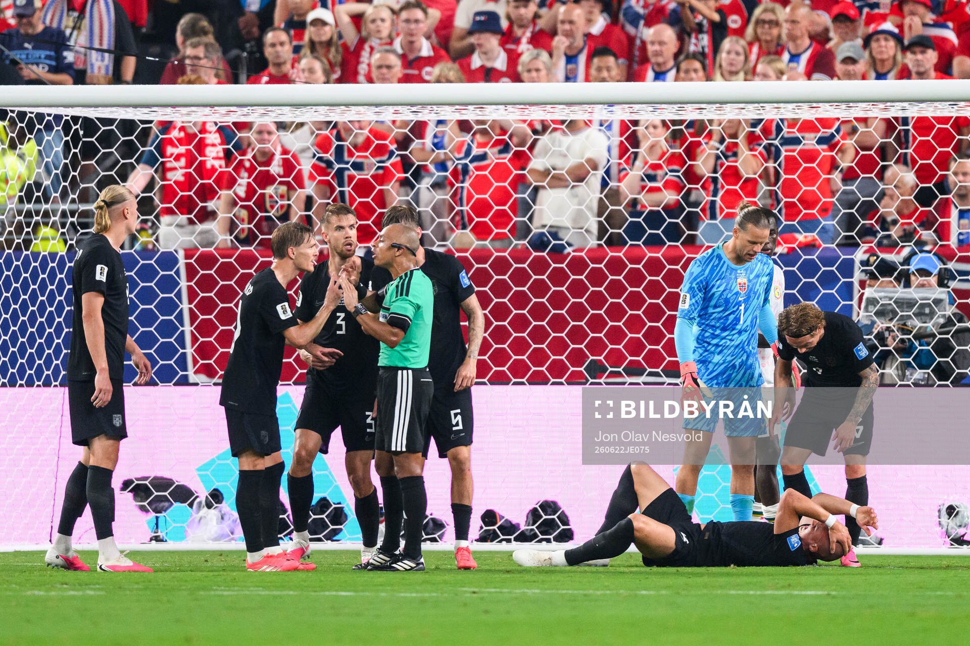 Leo Østigård of Norway in pain as Martin Ødegaard and