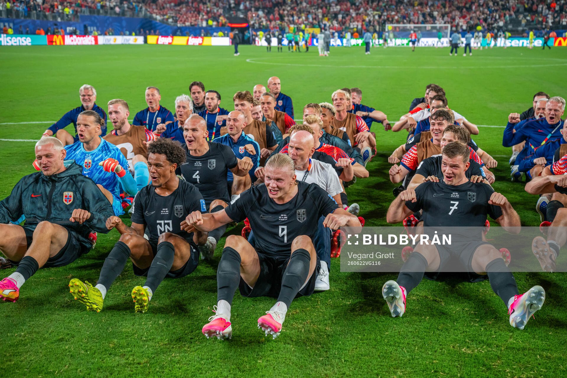 Players and staff of Norway celebrate with a viking row
