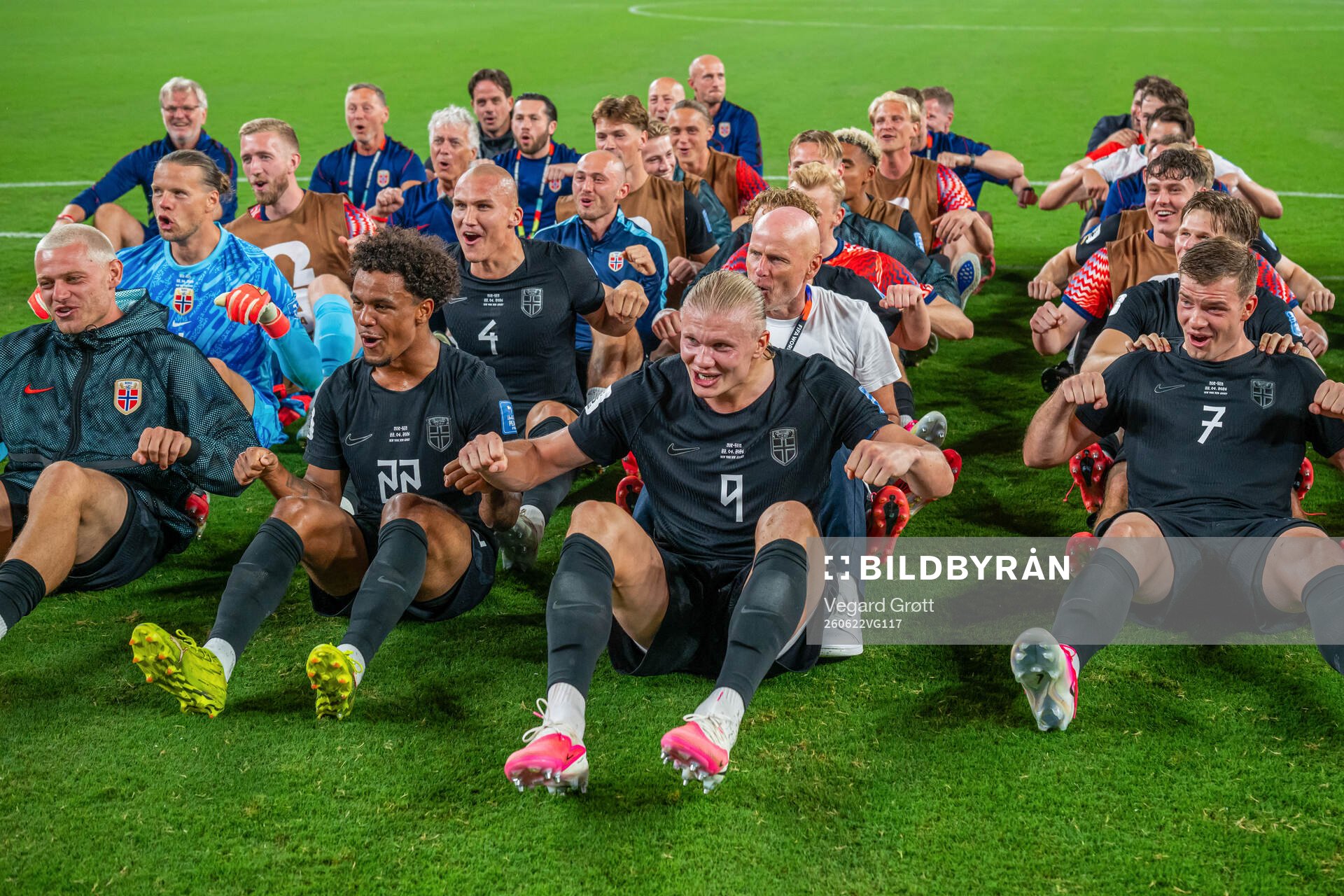 Players and staff of Norway celebrate with a viking row