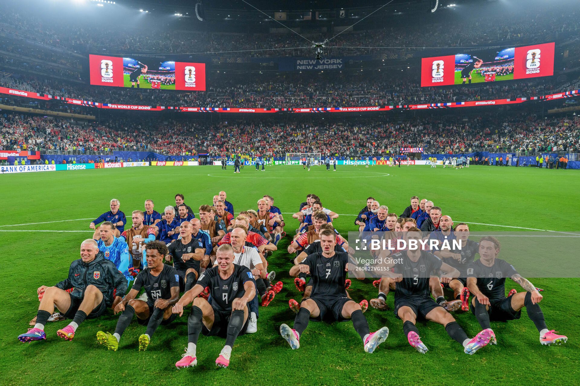 Players and staff of Norway celebrate with a viking row the