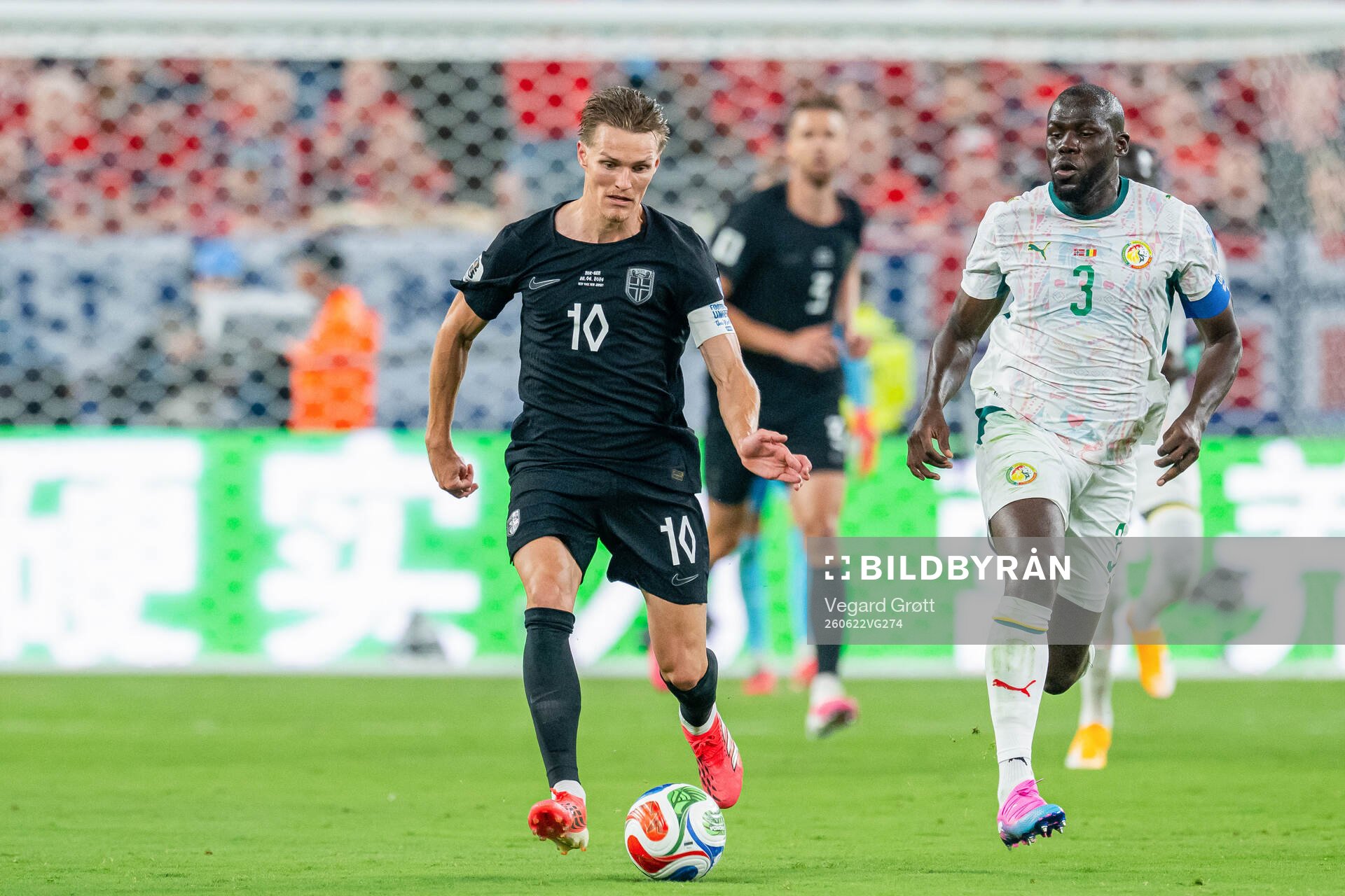 Martin Ødegaard of Norway and Kalidou Koulibaly of Senegal