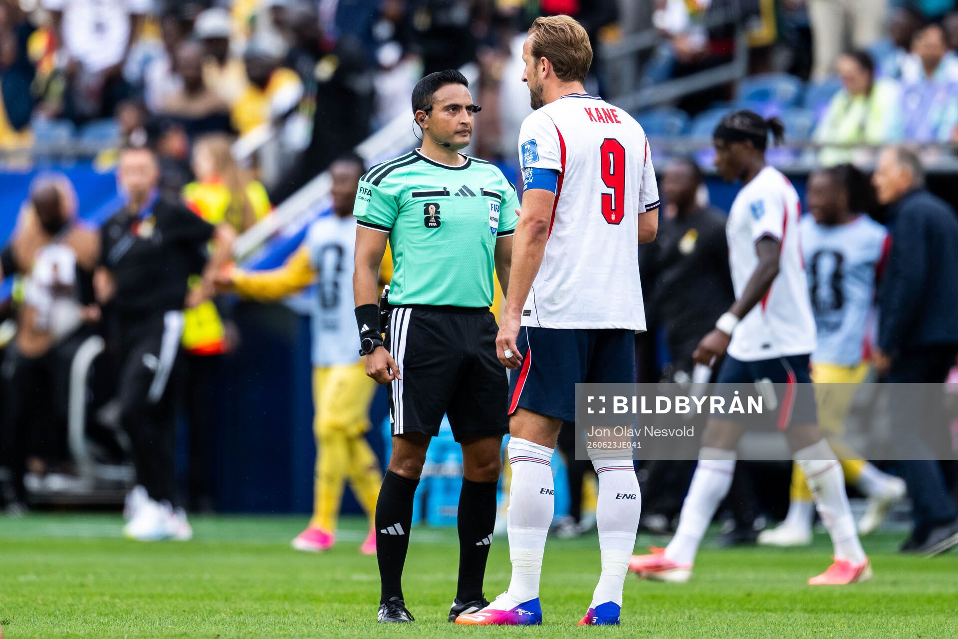 Referee Said Martinez and Harry Kane of England
