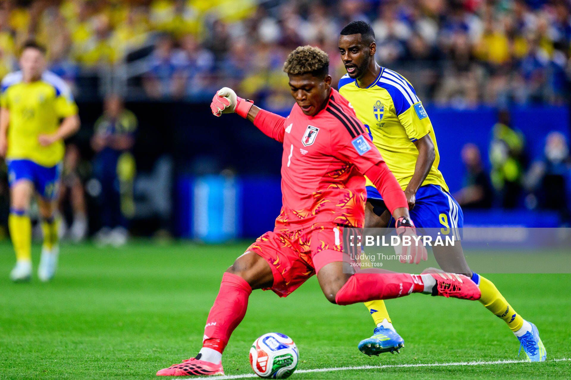 Goalkeeper Zion Suzuki of Japan and Alexander Isak of Sweden