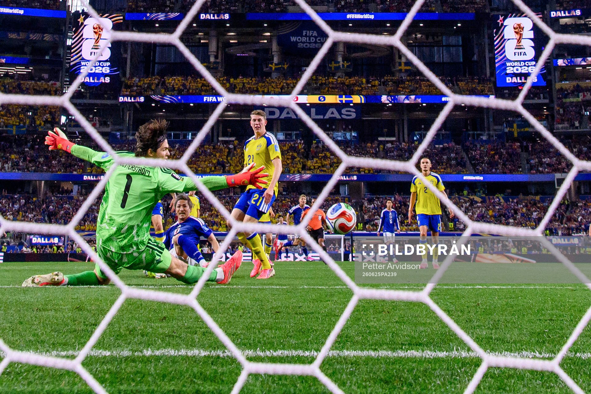 Daizen Maeda of Japan scores 1-0 behind goalkeeper Jacob