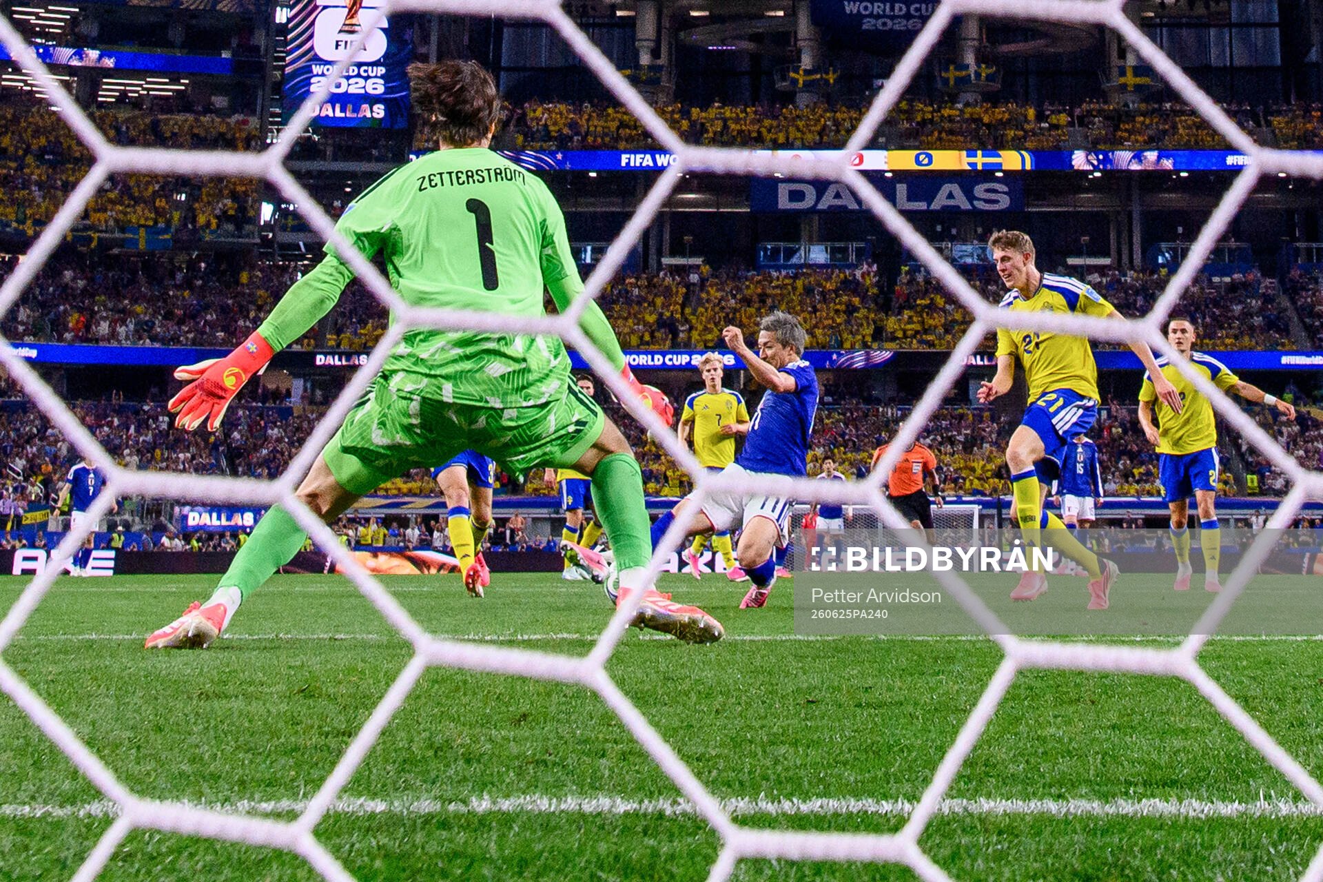 Daizen Maeda of Japan scores 1-0 behind goalkeeper Jacob