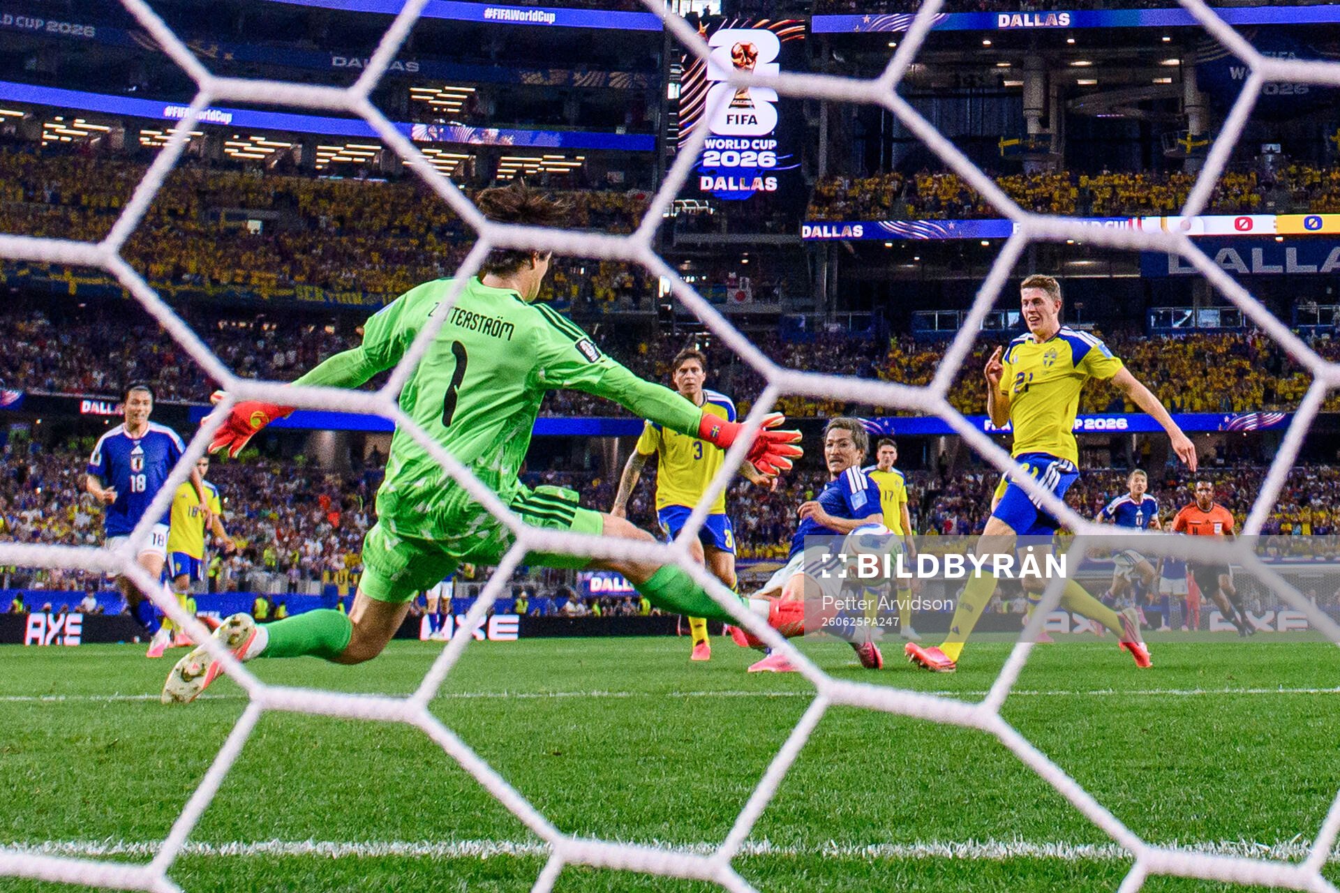 Daizen Maeda of Japan scores 1-0 behind goalkeeper Jacob
