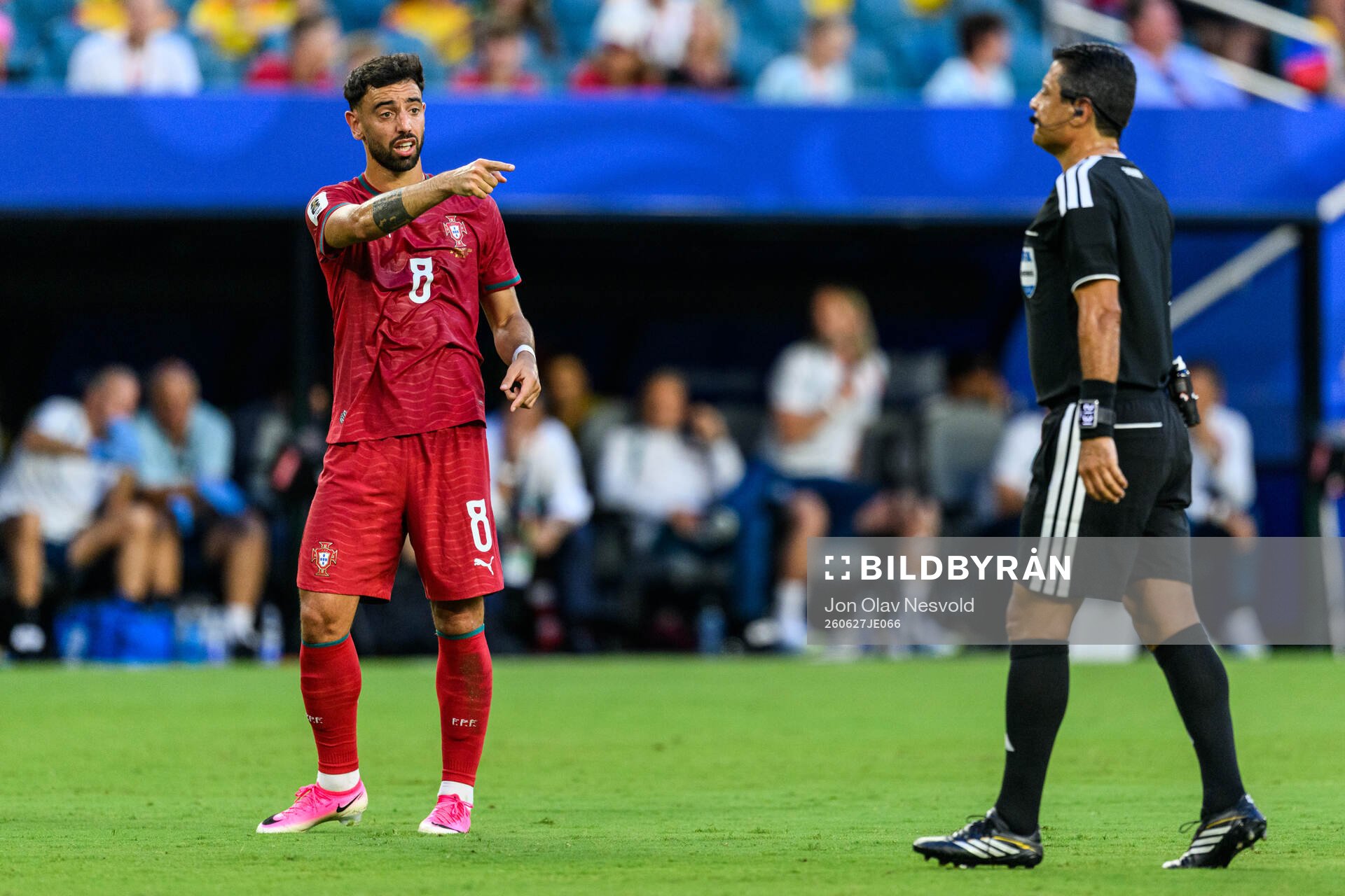 Bruno Fernandes of Portugal and Referee Alireza Faghani