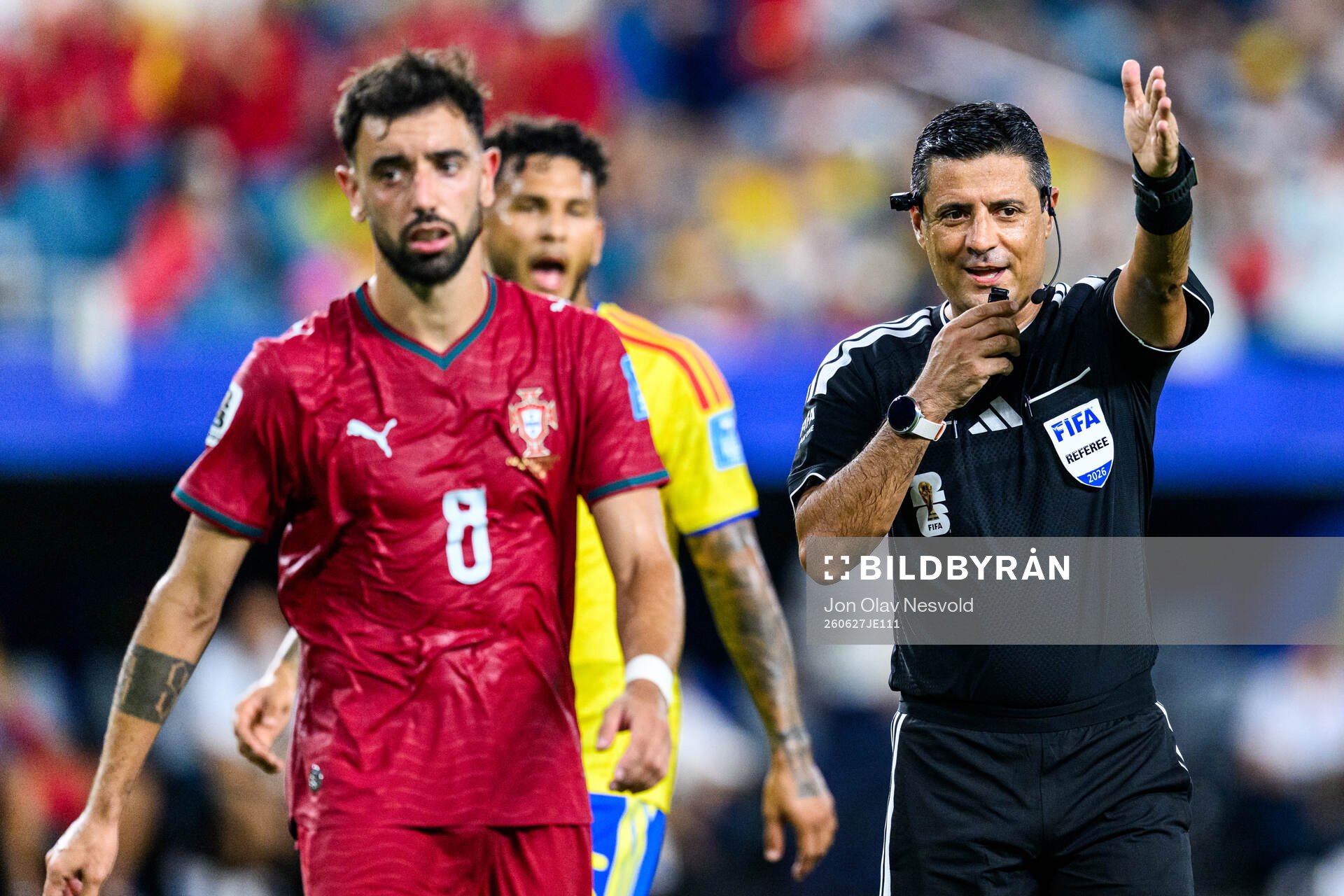 Bruno Fernandes of Portugal and Referee Alireza Faghani
