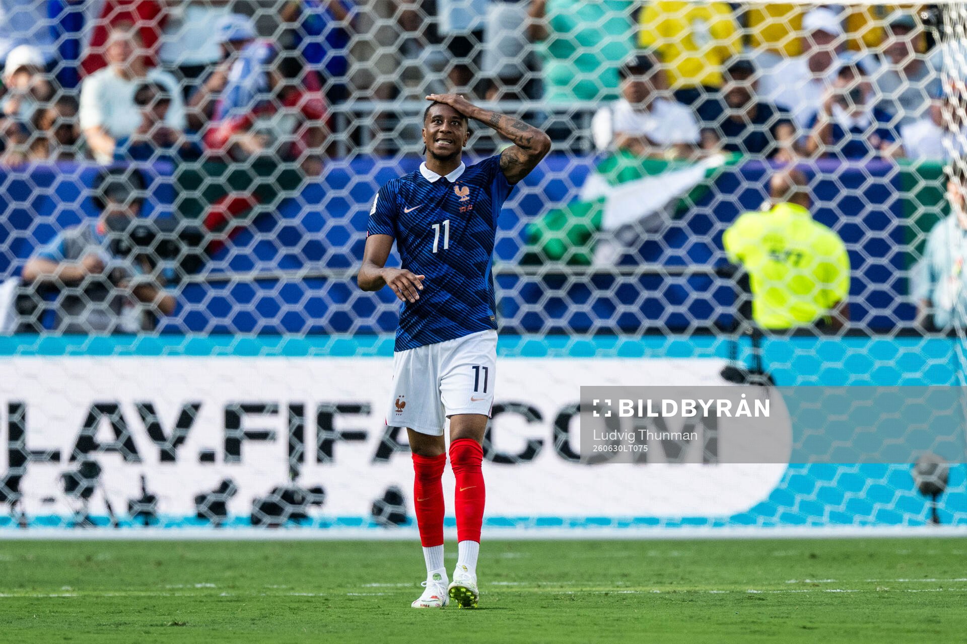 Michael Olise of France looks dejected