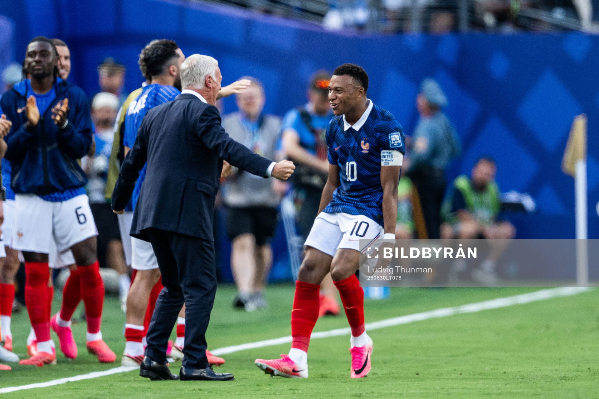 Kylian Mbappe of France celebrates with head coach Didier