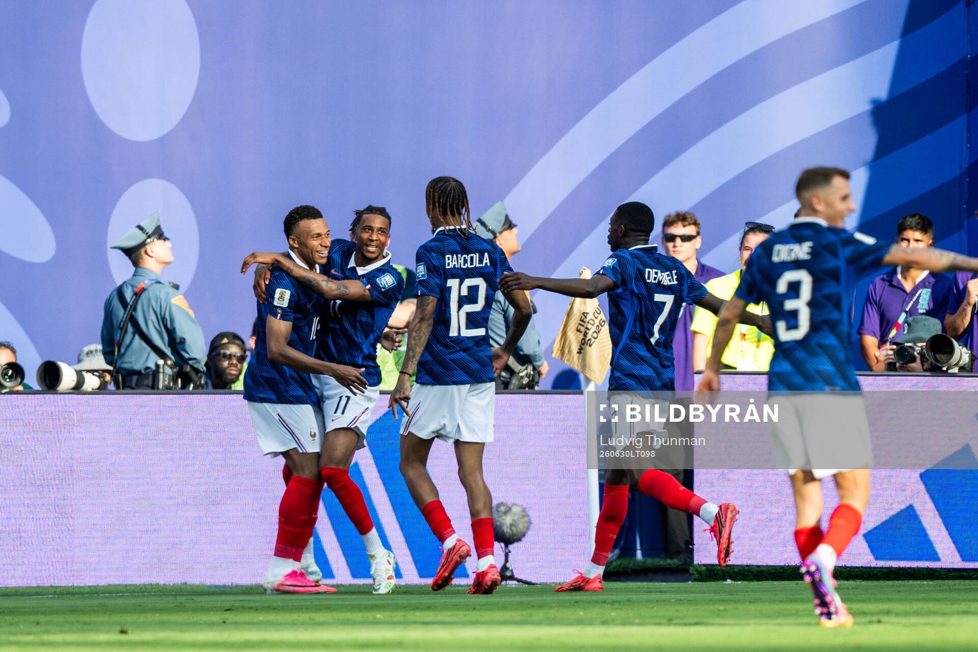 Kylian Mbappe of France celebrates with Michael Olise,