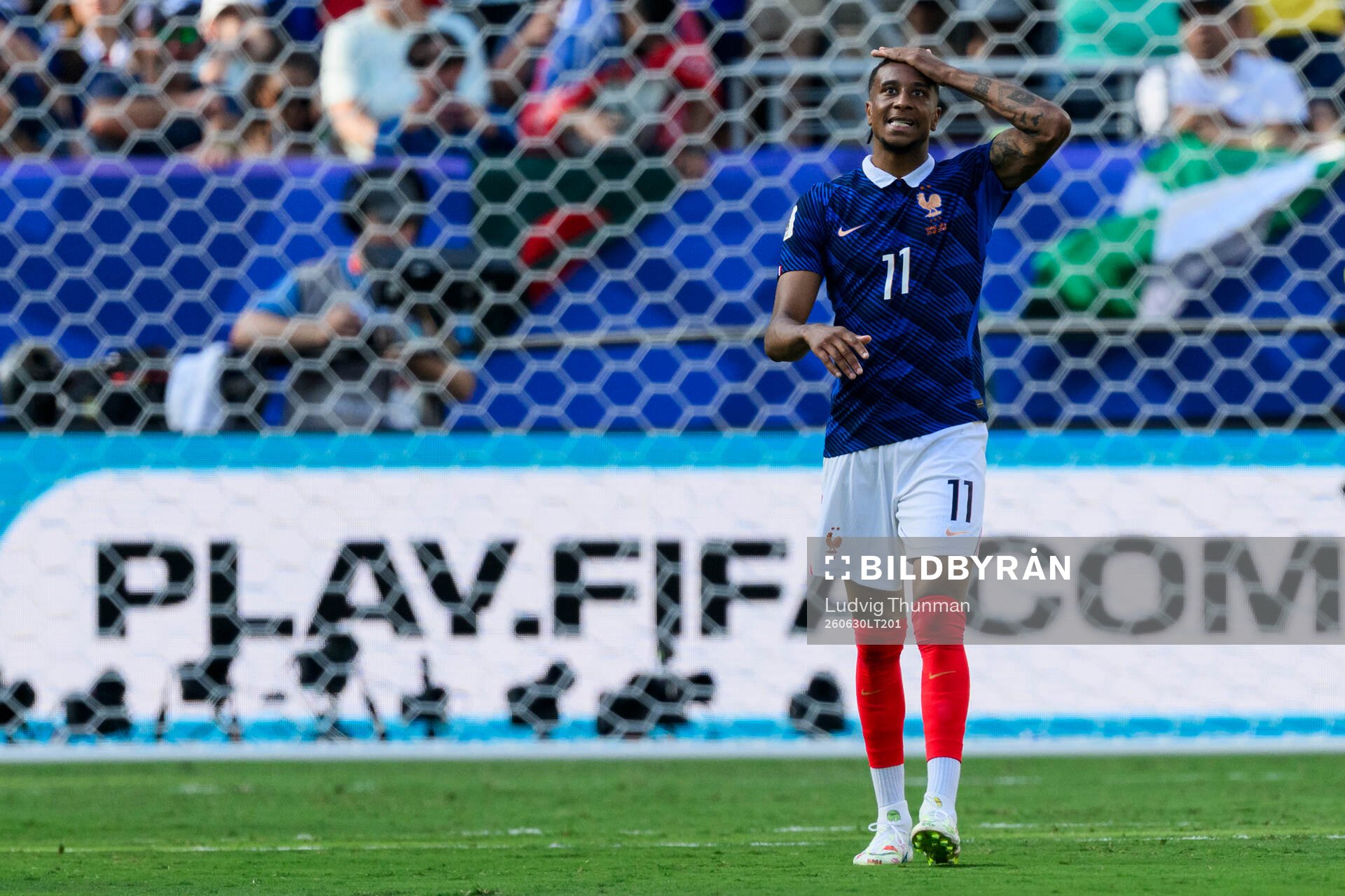 Michael Olise of France looks dejected