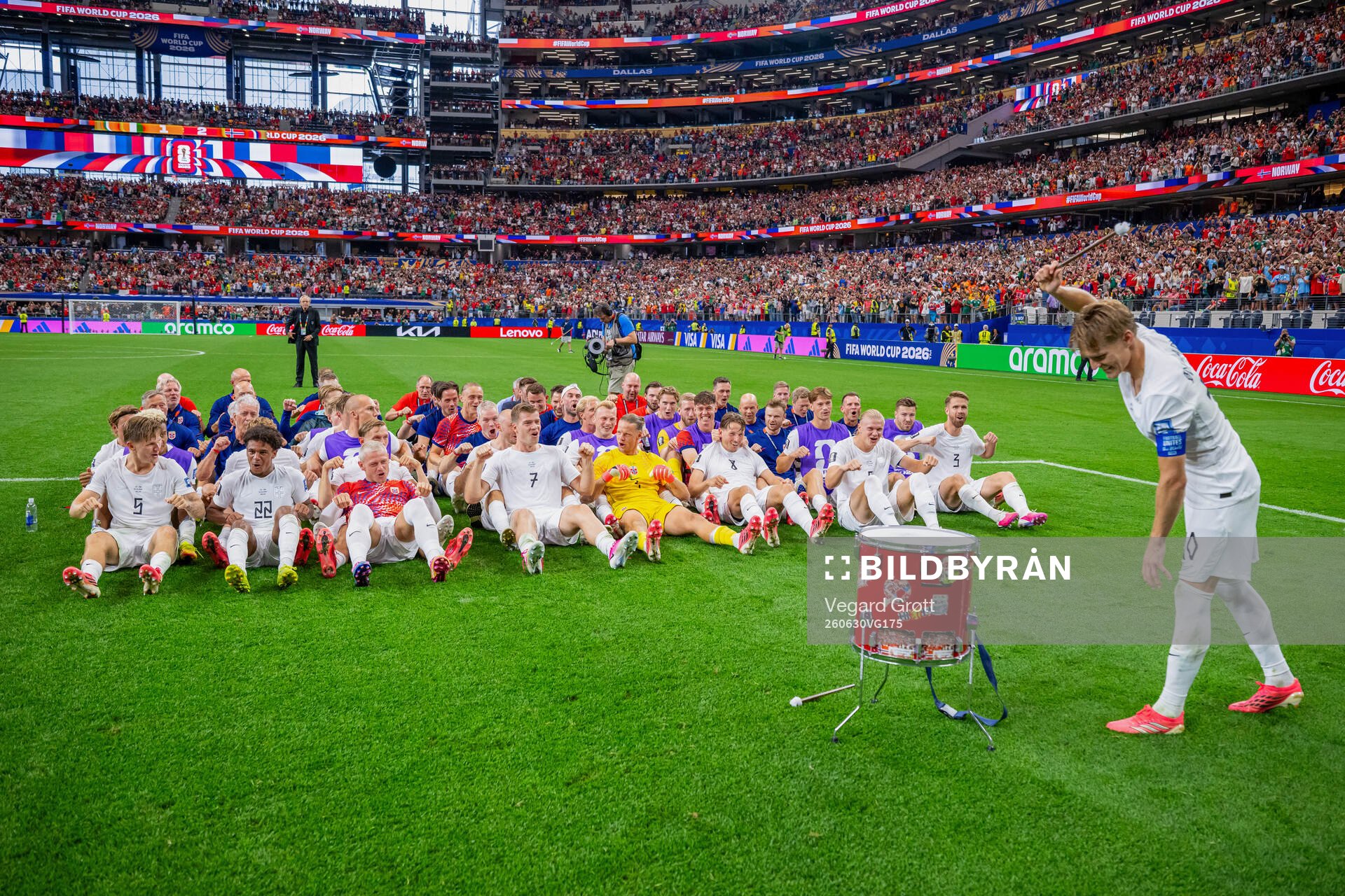 Players and staff of Norway celebrate with a viking row