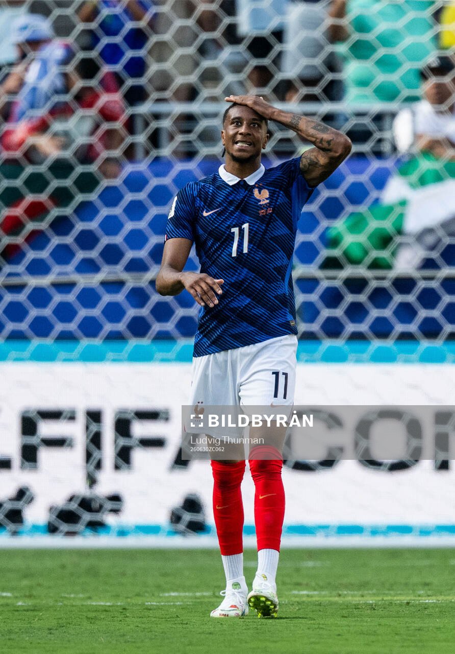 Michael Olise of France looks dejected