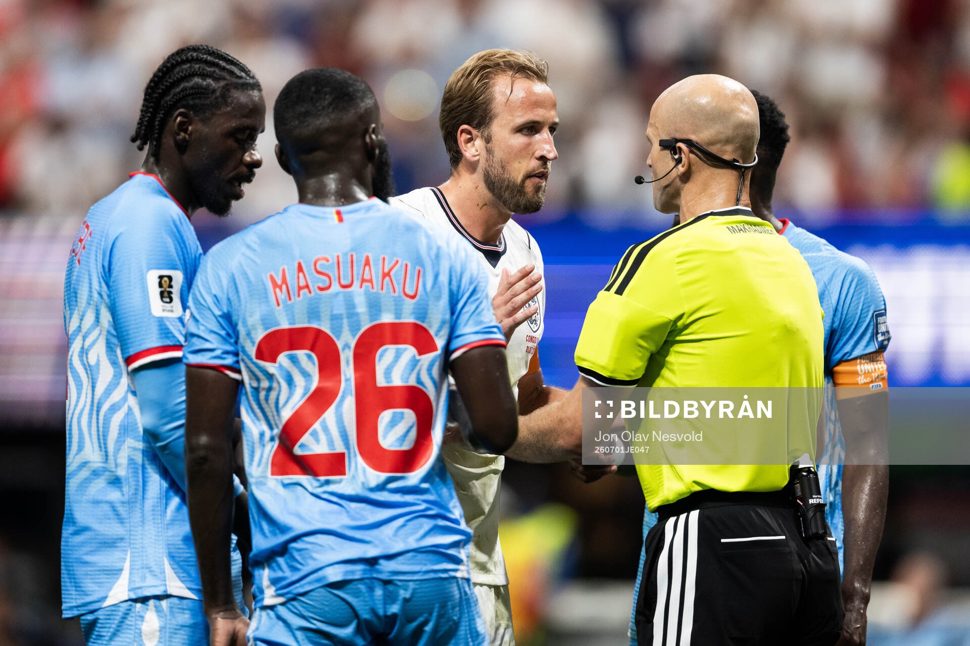 Harry Kane of England in a discussion with the referee