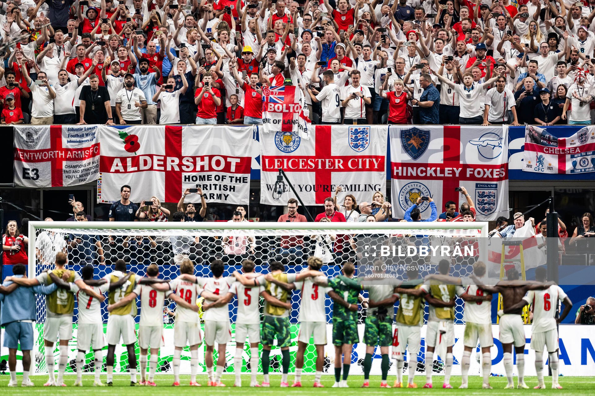Supporters of England celebrate together with the team