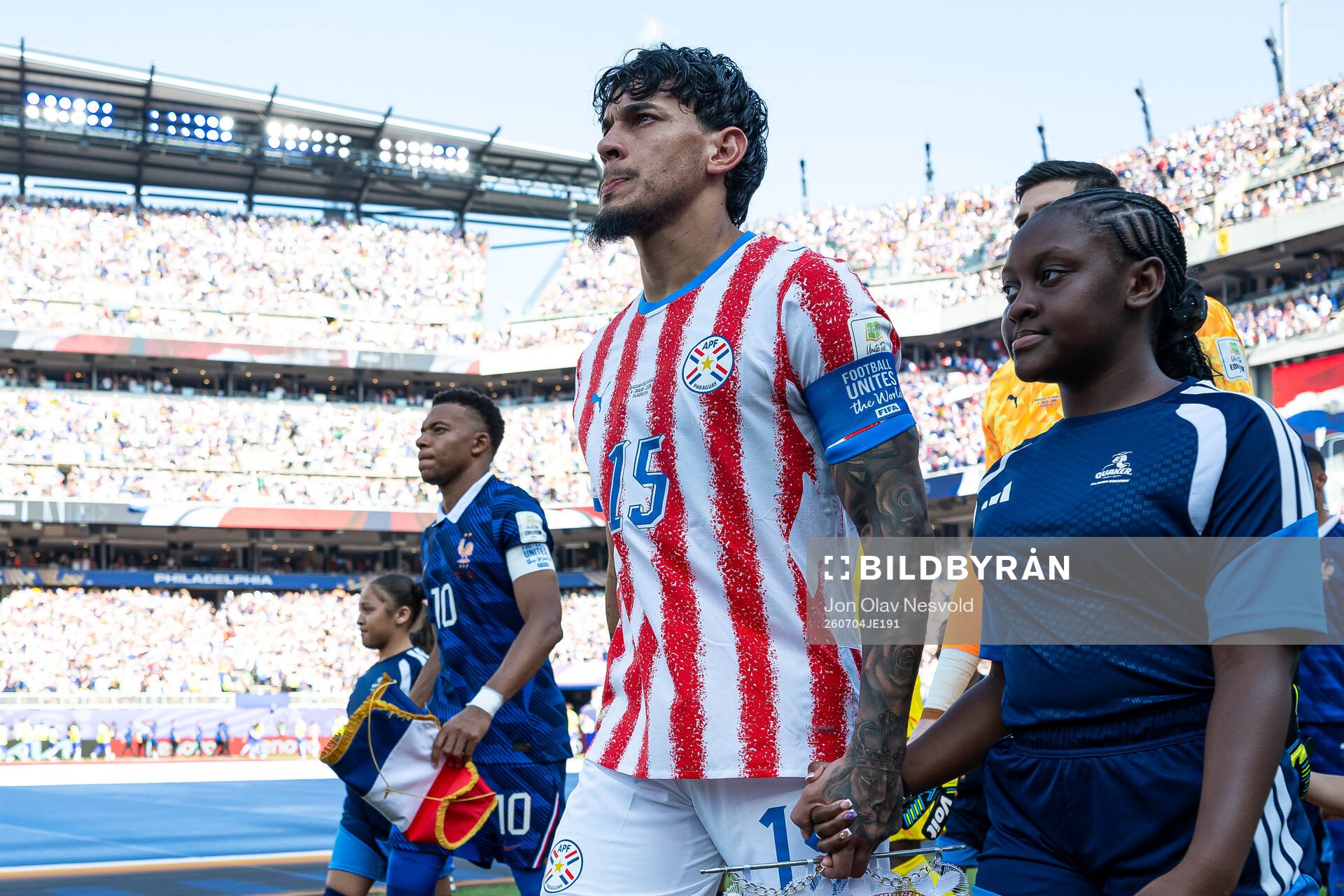 Kylian Mbappe of France and Gustavo Gomez of Paraguay
