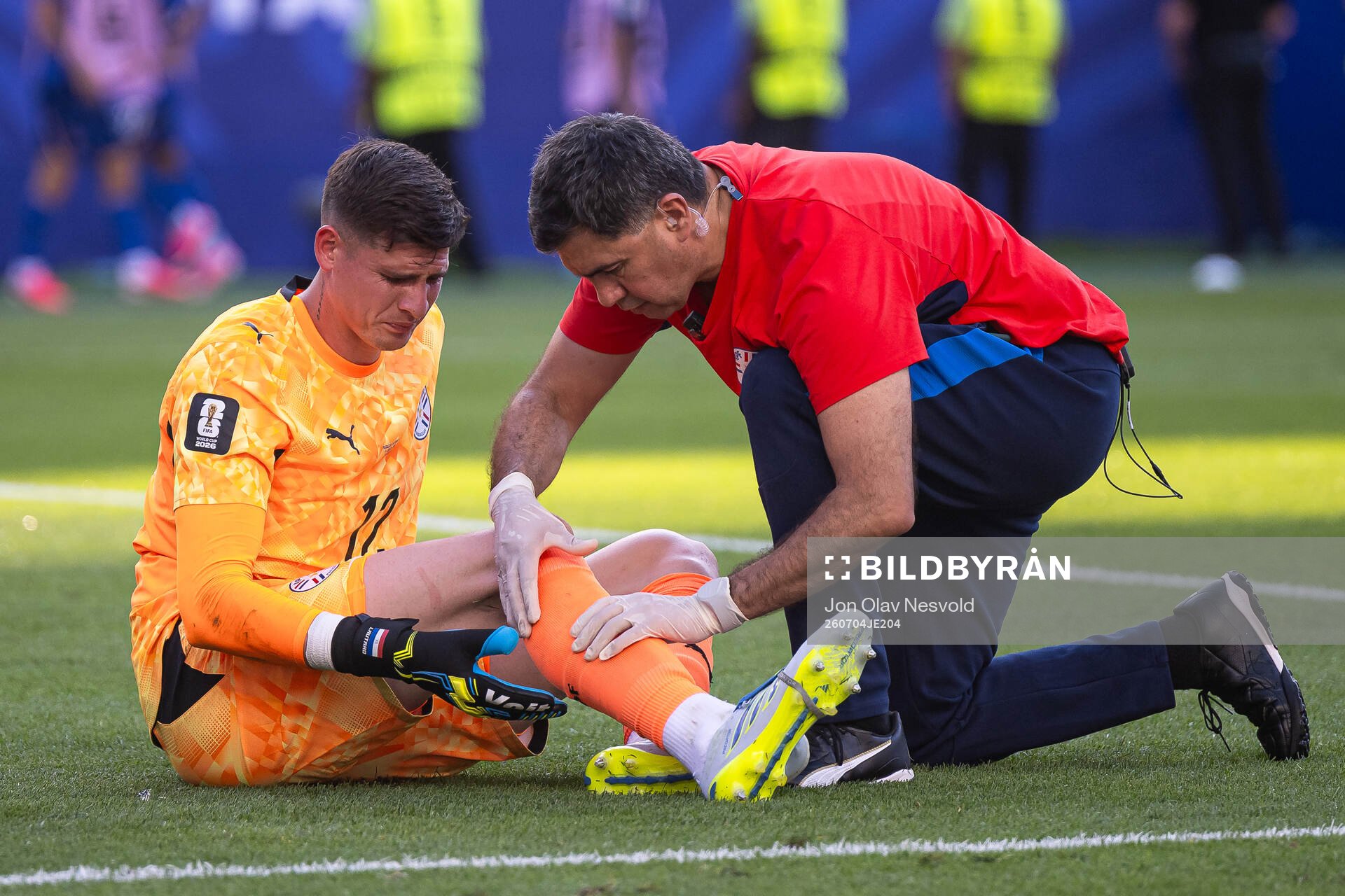 Goalkeeper Orlando Gill of Paraguay receives medical
