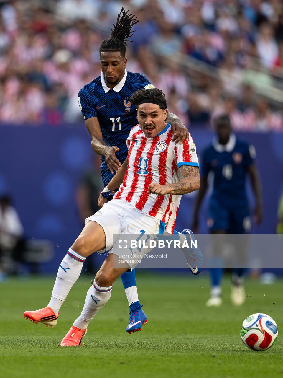 Michael Olise of France and Mauricio of Paraguay