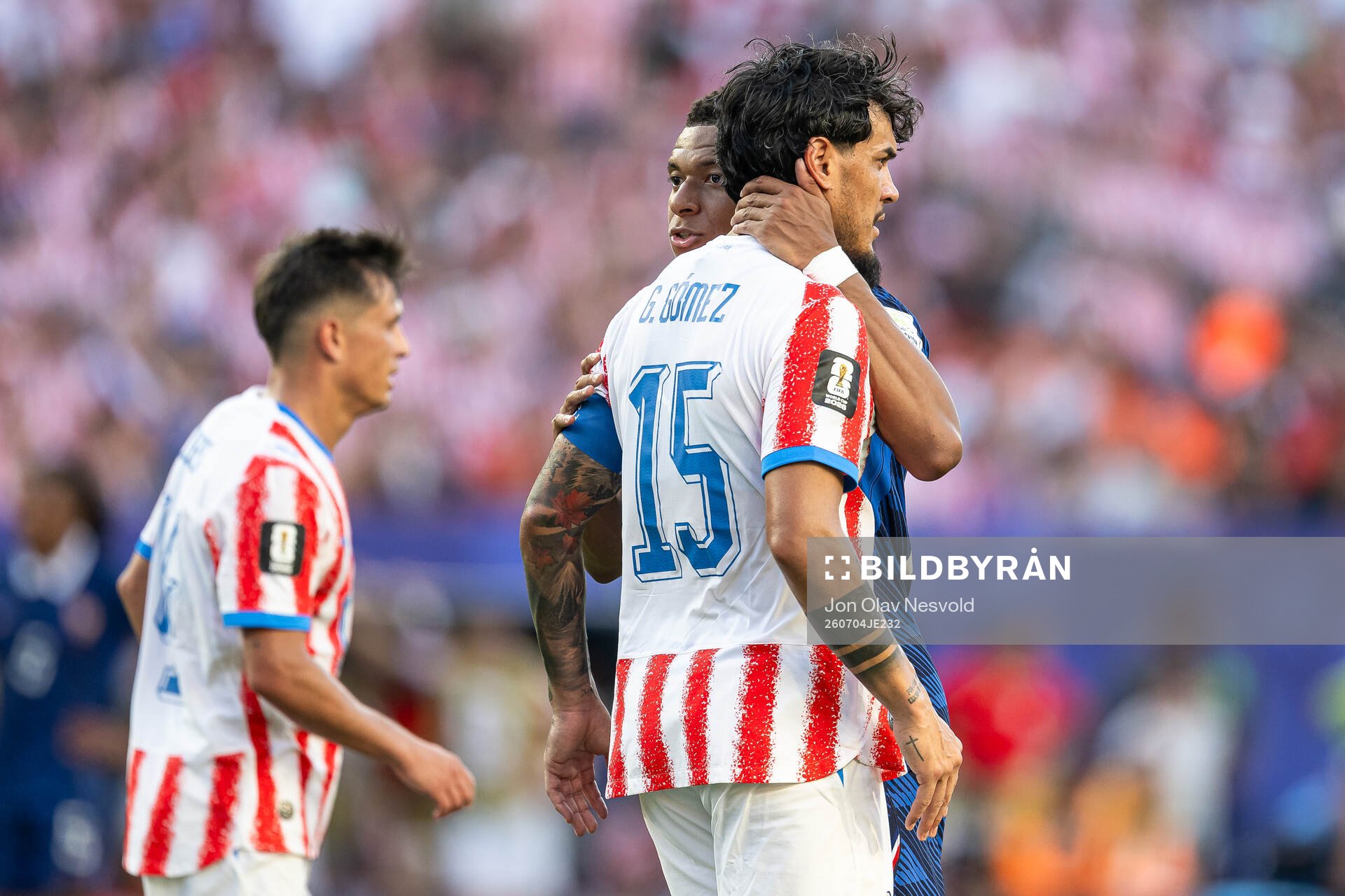 Kylian Mbappe of France and Gustavo Gomez of Paraguay