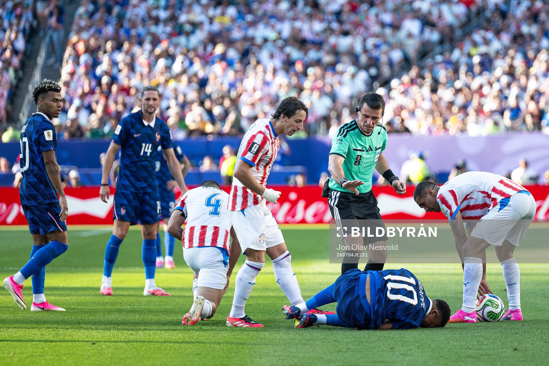 Referee Ilgiz Tantashev and Kylian Mbappe of France