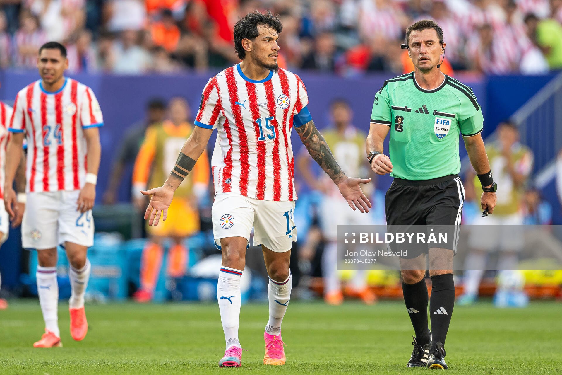 Gustavo Gomez of Paraguay and Referee Ilgiz Tantashev