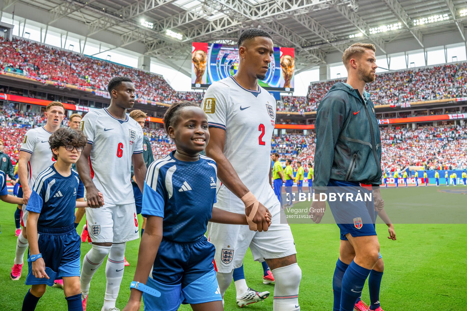 Ezri Konsa of England and Kristoffer Ajer of Norway enter